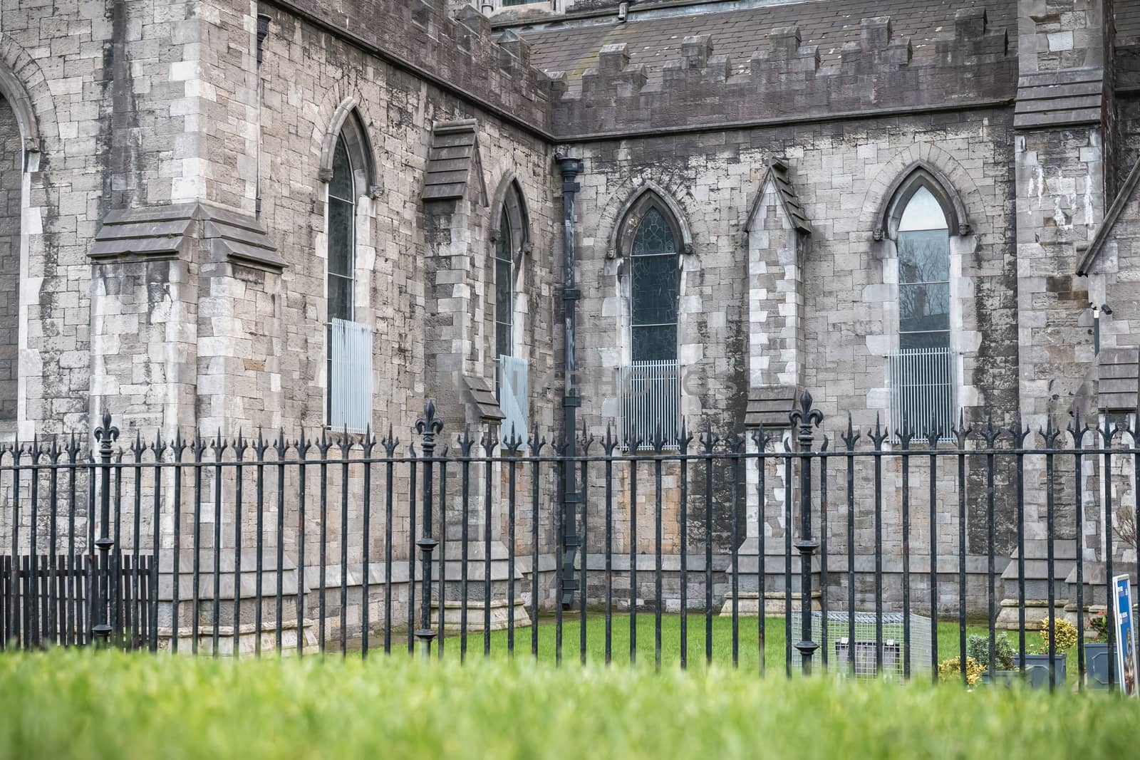 Dublin, Ireland - February 13, 2019: Street atmosphere and architecture of St Patrick's Cathedral that people visit on a winter day