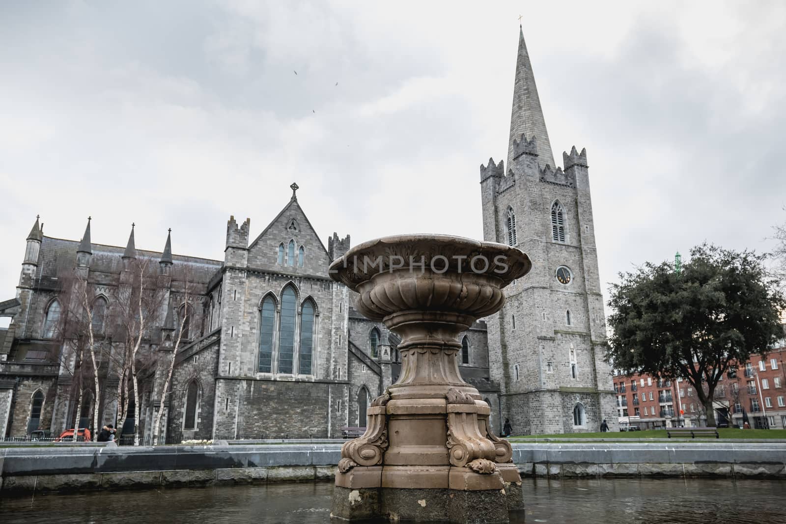 Dublin, Ireland - February 13, 2019: Street atmosphere and architecture of St Patrick's Cathedral that people visit on a winter day