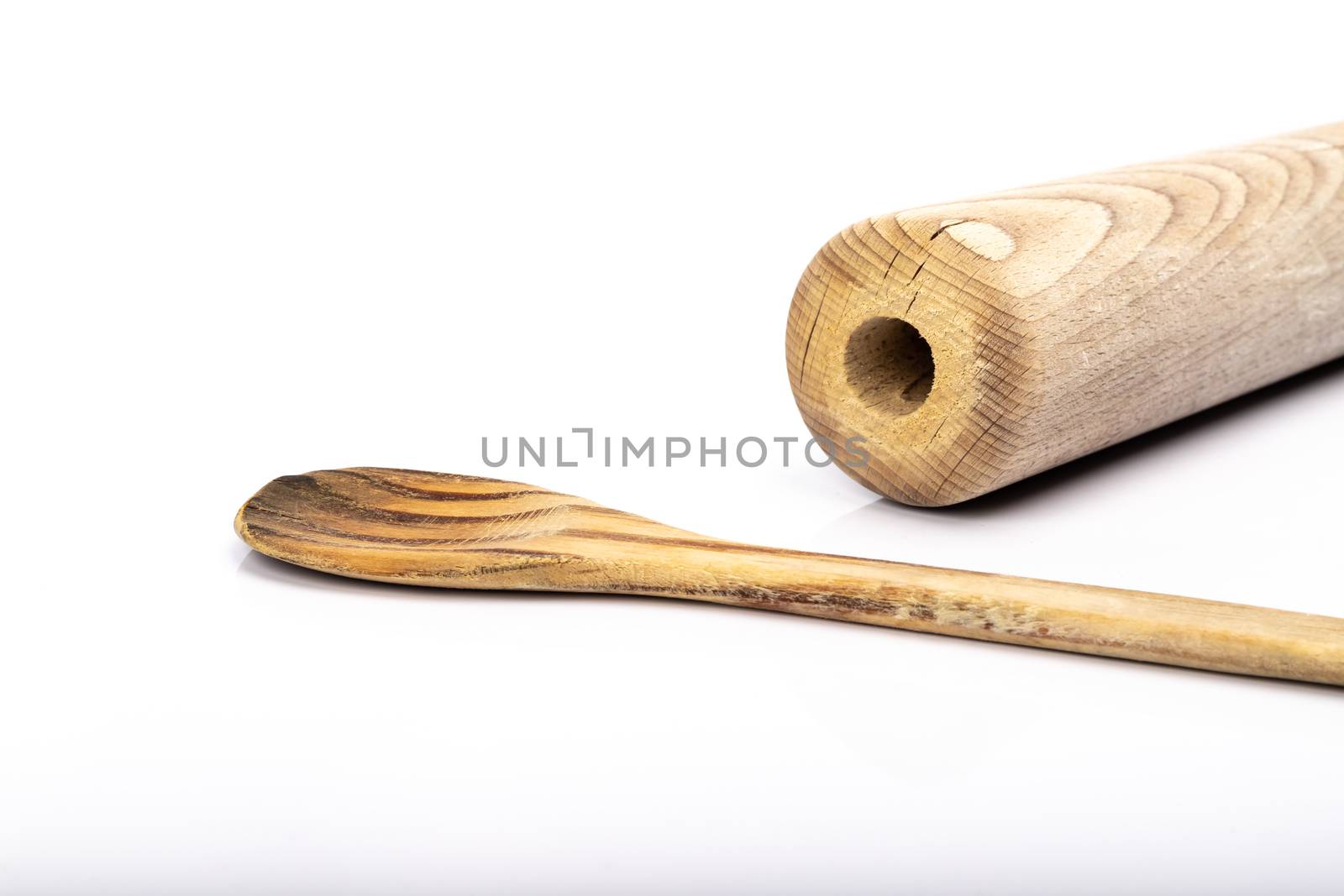 wooden spoon and rolling pin on white background in studio