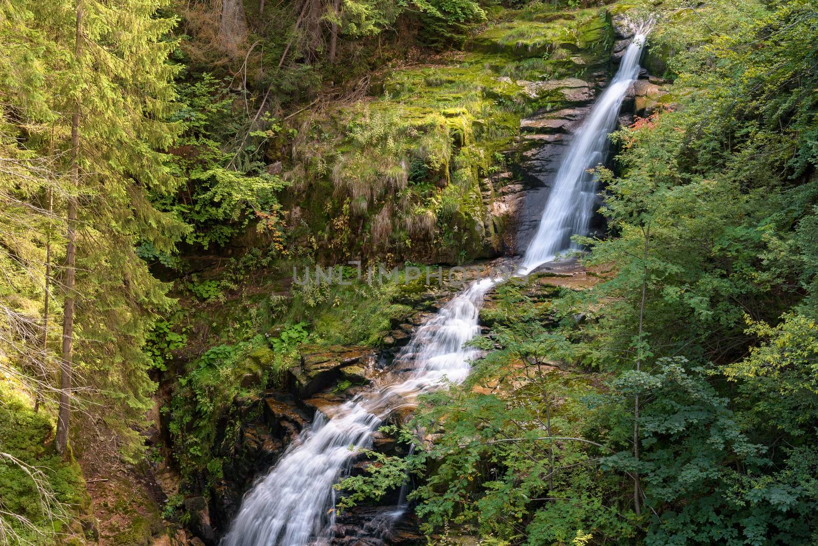 Blurred water of waterfall of Kamienczyk river - the highest waterfall in polish Giant Mountains