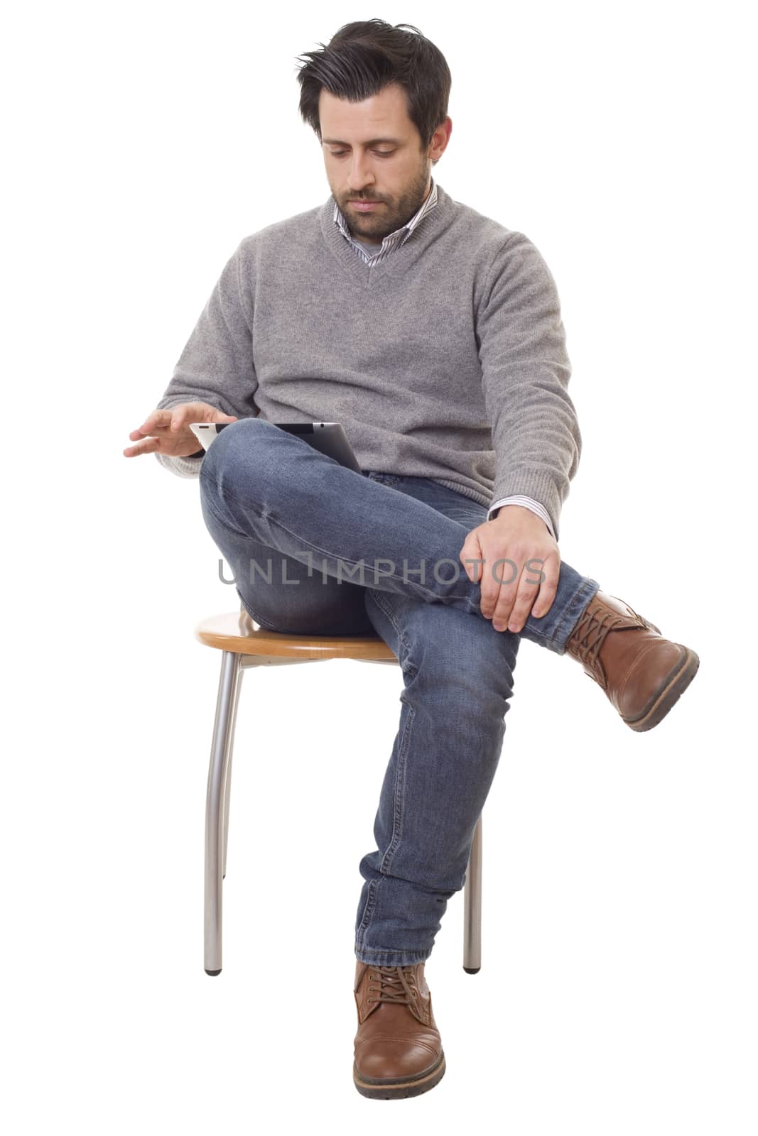 happy casual man on a chair with a tablet pc, isolated on white background