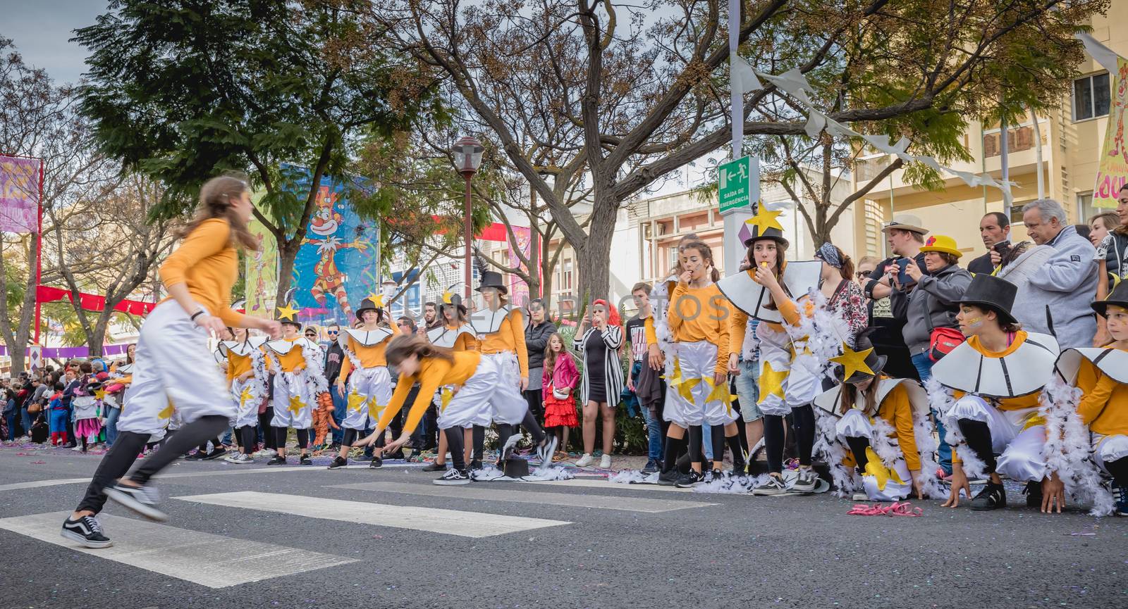 Loule, Portugal - February 25, 2020: dancers parading in the street in front of the public in the parade of the traditional carnival of Loule city on a February day