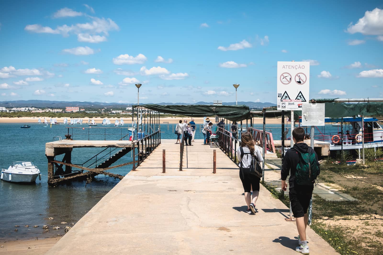 ilha de tavira, portugal - may 3, 2018: people riding in a taxi boat on the island towards the continent on a spring day