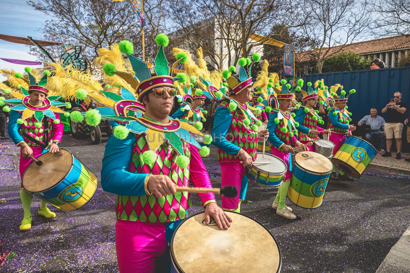 Loule, Portugal - February 25, 2020: percussionists parading in the street accompanying dancers in the parade of the traditional carnival of Loule city on a February day