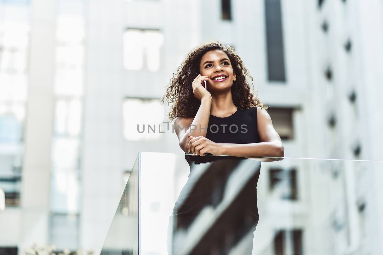 Happy smiling afroamerican woman have a nice conversation at street.