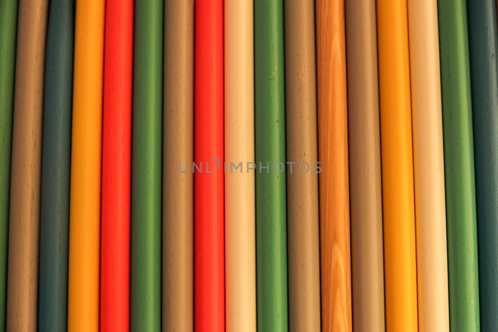 Close up of colored wooden drum sticks arranged in a row