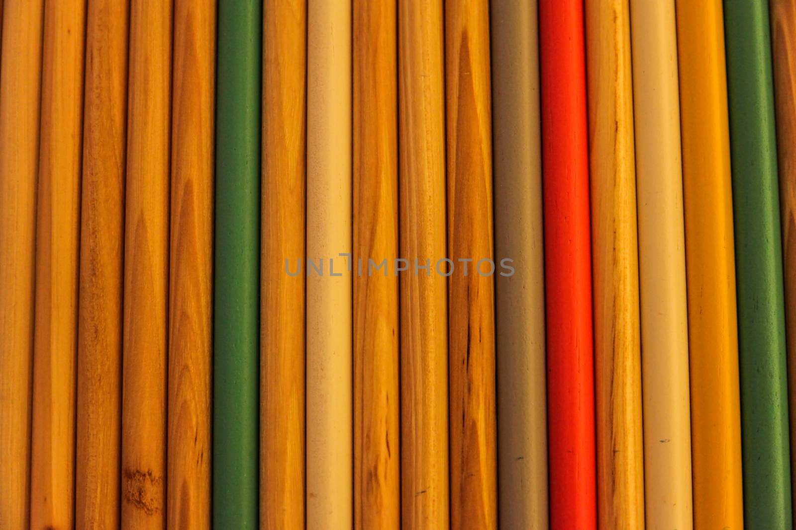 Close up of colored wooden drum sticks arranged in a row