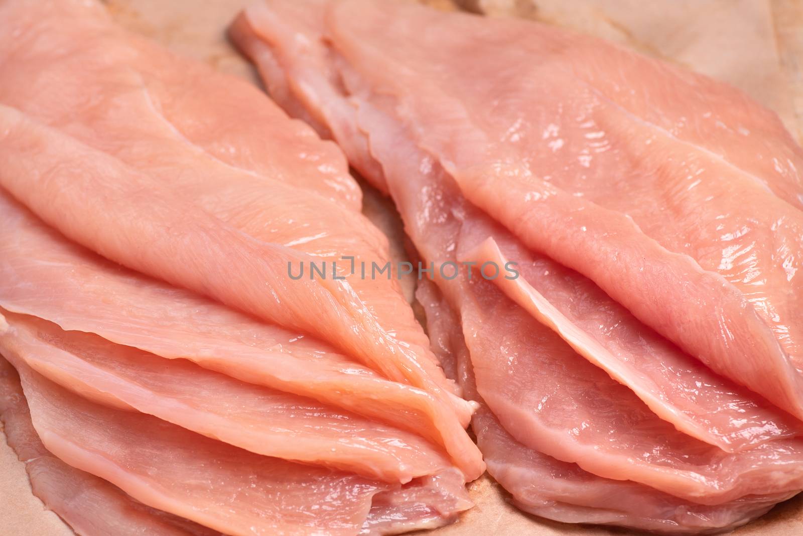 Raw sliced chicken meat close-up. Sotilissimo. Delicious dietary meat.Close-up view of raw, fresh, choped and sliced chicken meat Cooking,food of meat and fillets.