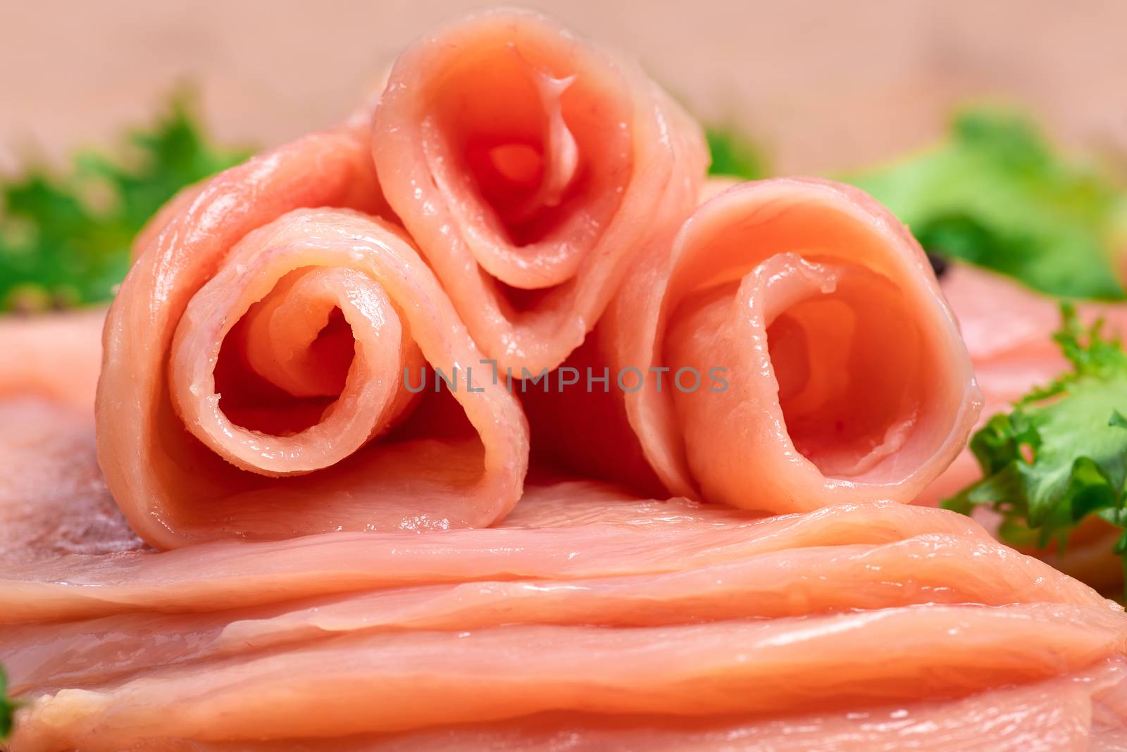 Raw chicken slices on a wooden table with raw vegetables and spices. Satilisimo. Delicious dietary meat. Close-up view of raw, fresh, choped and sliced chicken meat. Cooking,raw sliced chicken breast. by nkooume