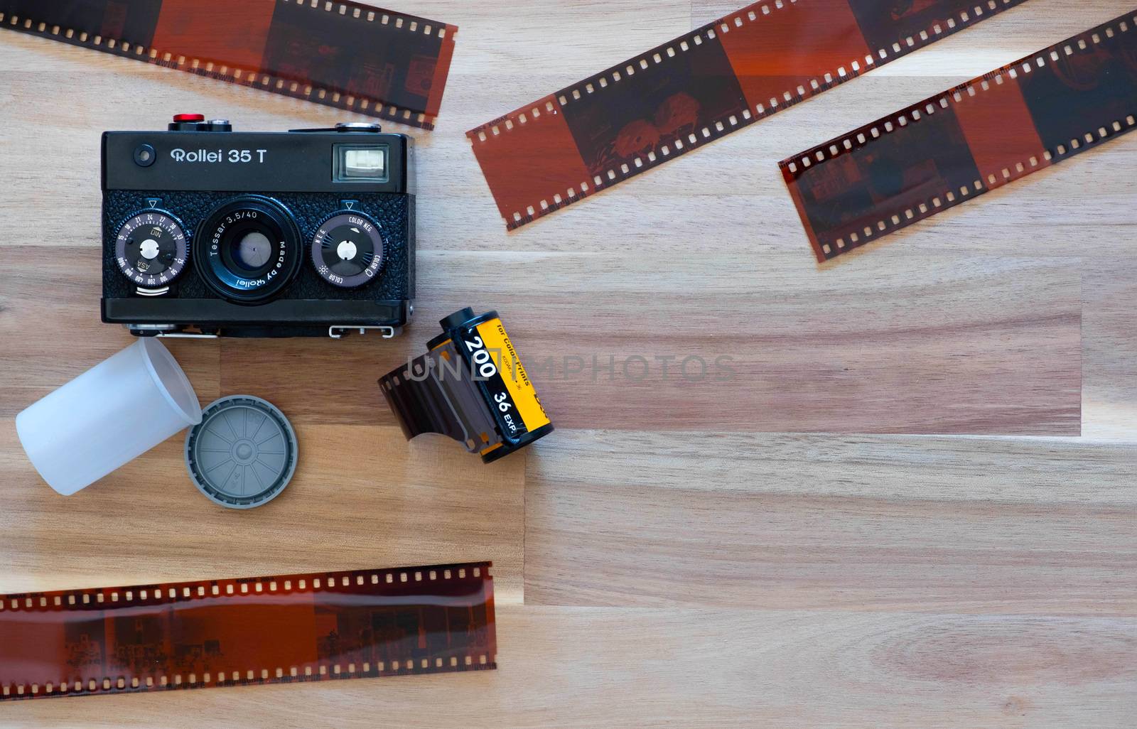 The Germany Film camera Rollei 35T with Kodak film and Lomography film and Film sheet on Wooden Background