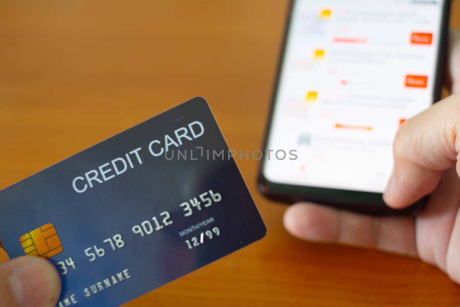 The Hands holding plastic credit card and using Mobile Phone for online shopping. Online shopping concept