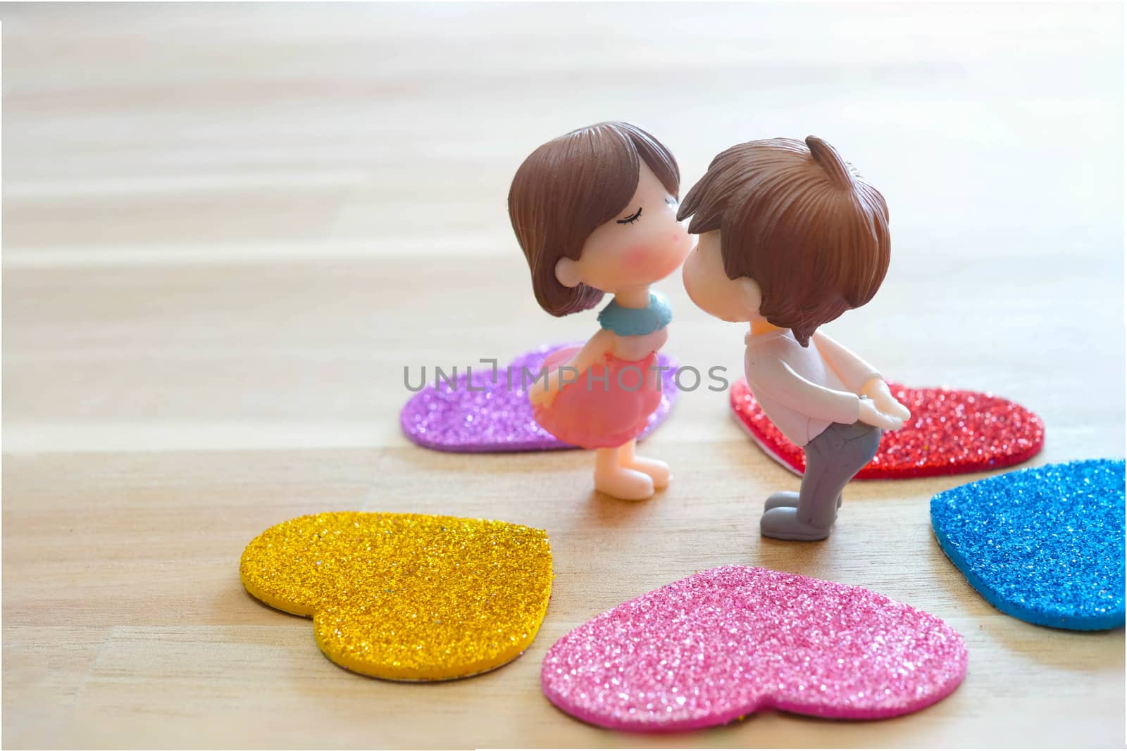 The Miniature Couple dolls Boy and Girl Romantic Kiss with Heart around the Ground  for Background for valentine's Day Concept