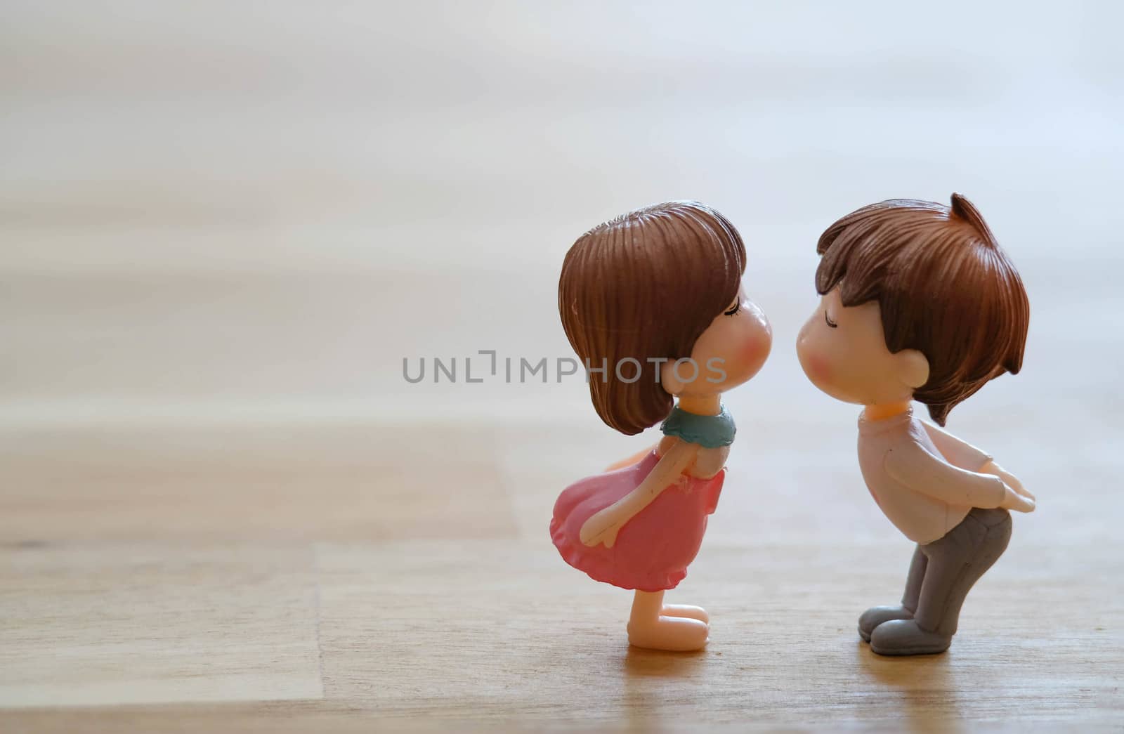 The Miniature Couple dolls Boy and Girl Romantic Kiss with Heart around the Ground  for Background for valentine's Day Concept