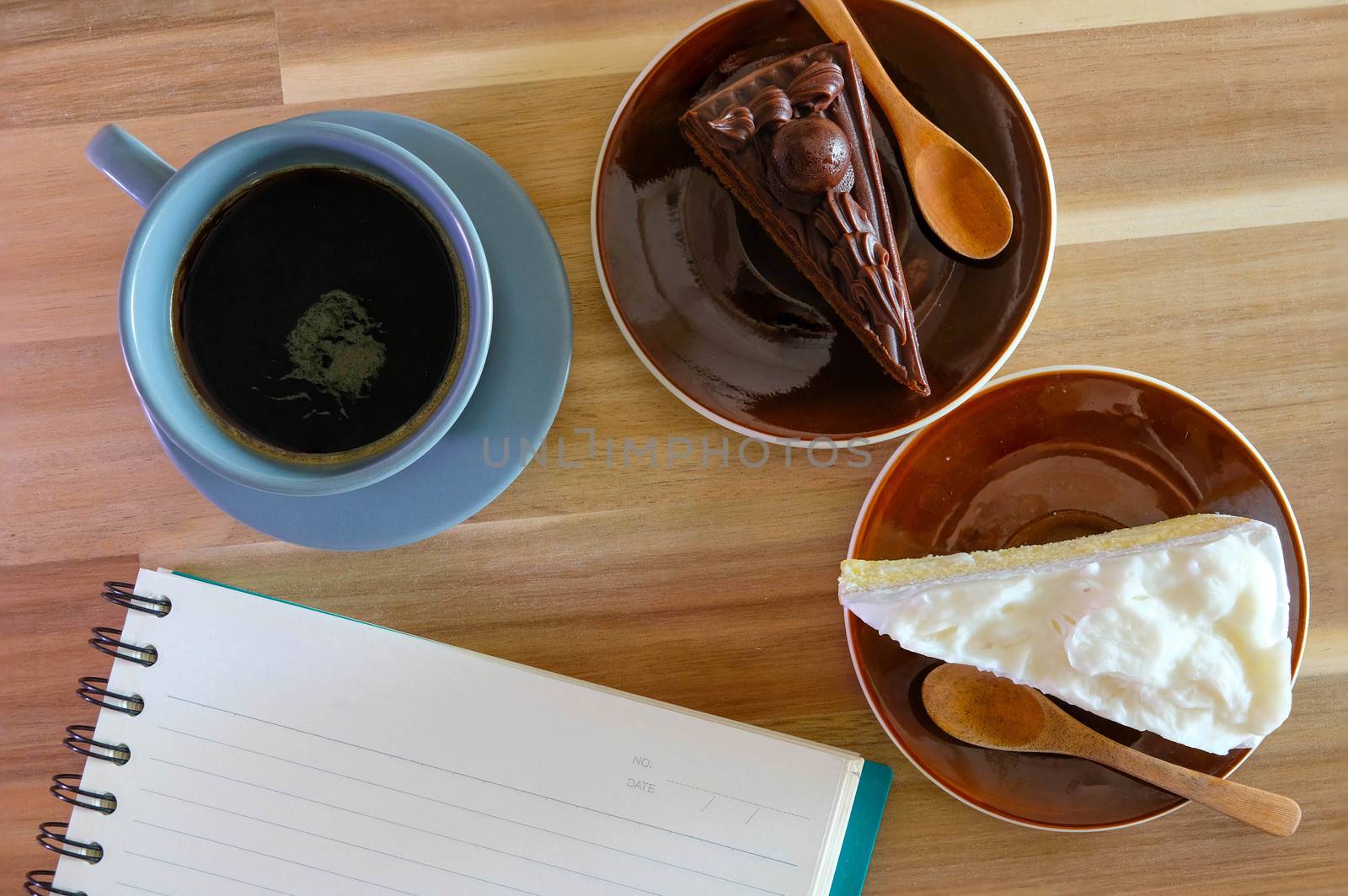 notebook, coffee, chocolate cake and Coconut cake on wooden background by Bonn2210