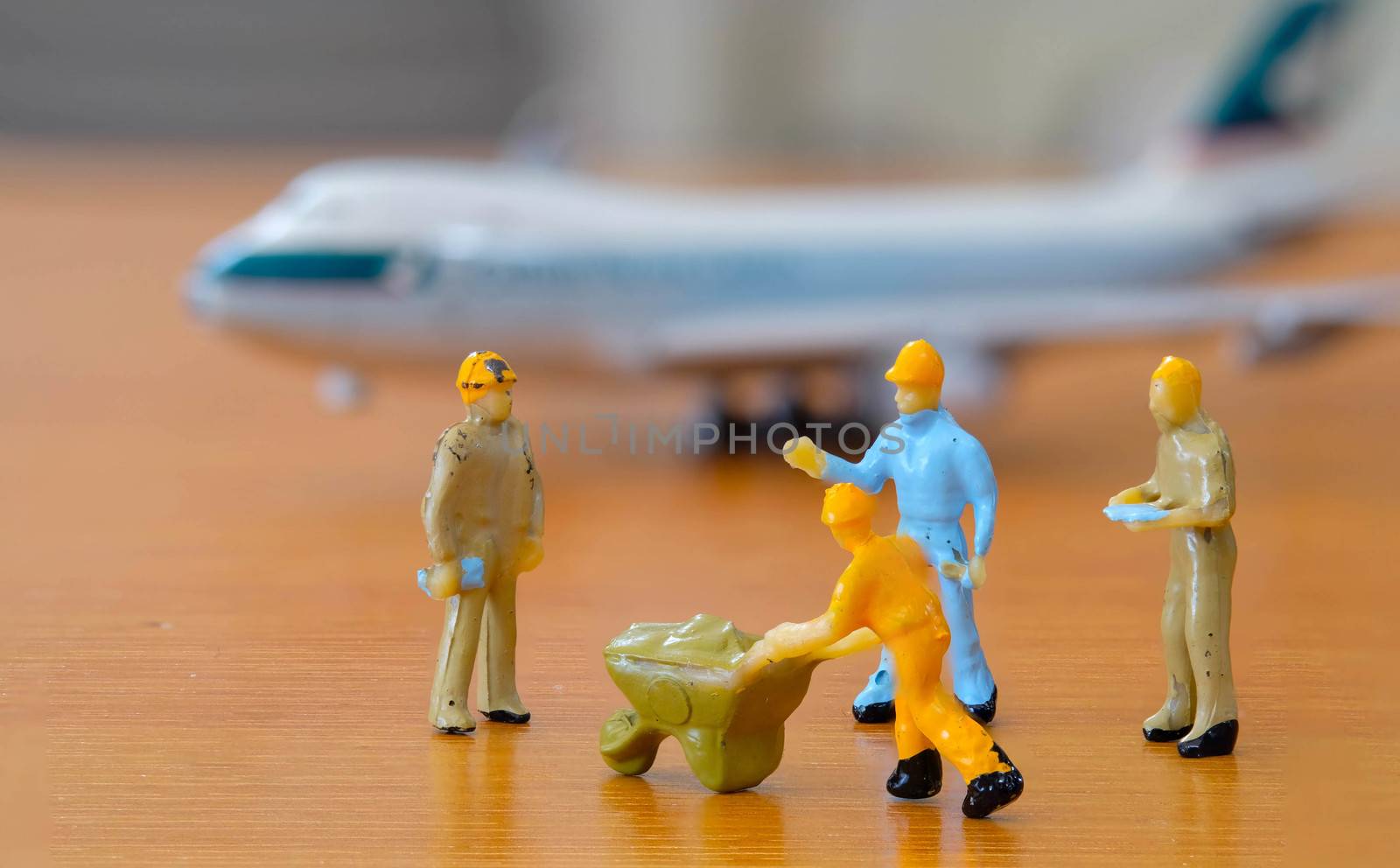 Airplane engineer, airport worker, aircraft people working in repairing the runway and Fix and checking the airplane. Many level of miniature company employee and employer figure as Airplane flight concept