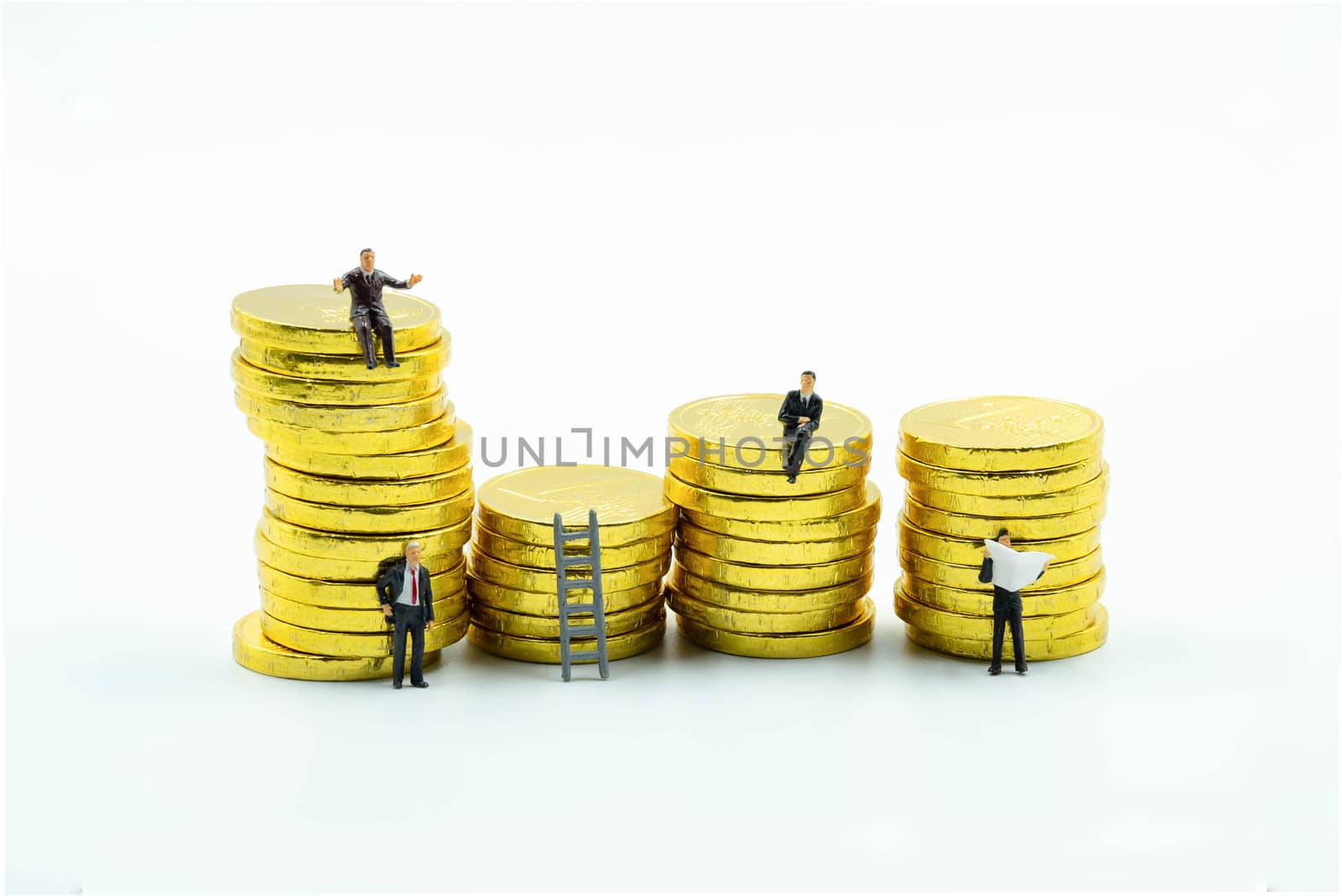 miniature figure a group of business men sitting on top of pile stack of golden coins and some standing reading newspaper and discuss to other   business success concept