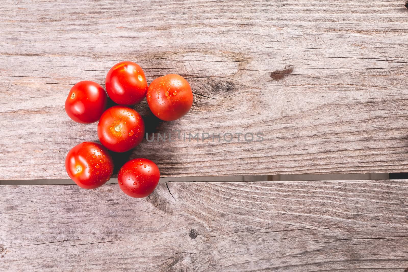 ripe tomatoes on wooden board in studio by AtlanticEUROSTOXX