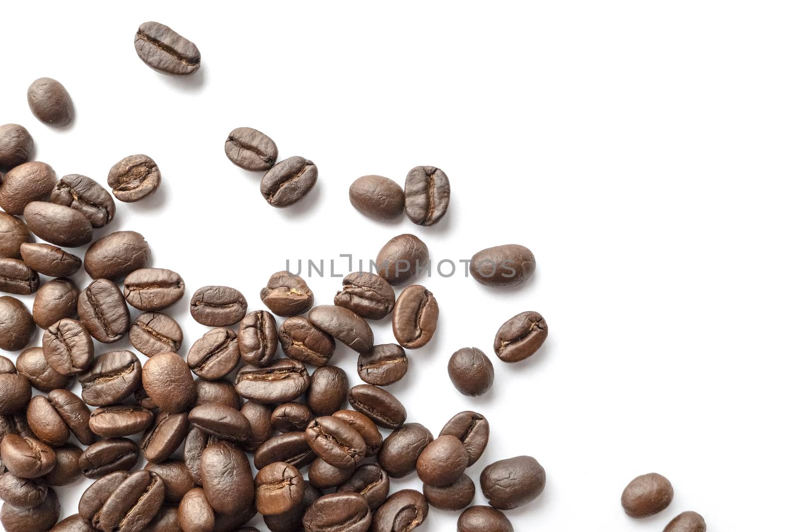 Roasted coffee beans isolated on white background. Close-up image.