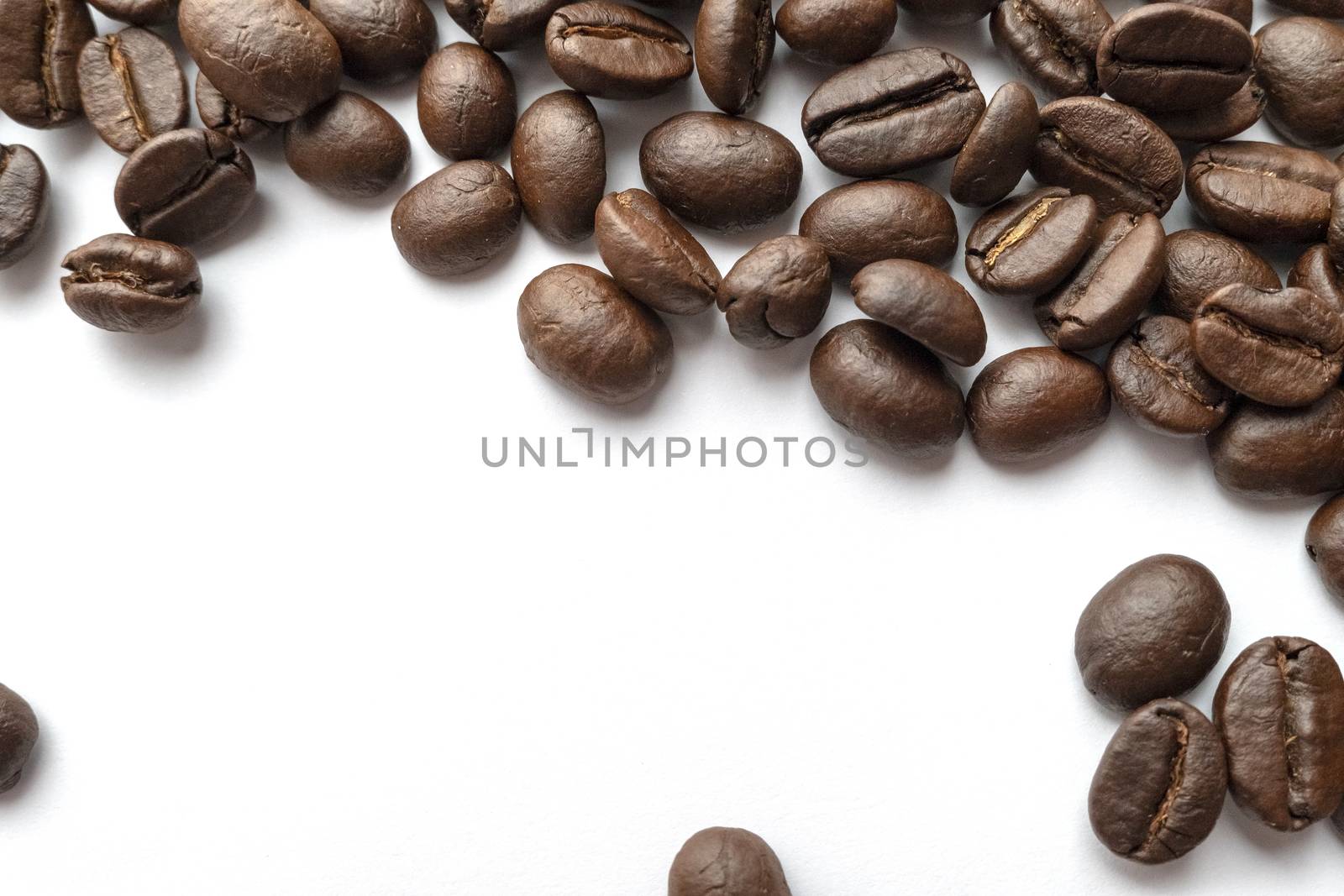 Roasted coffee beans isolated on white background. Close-up image.