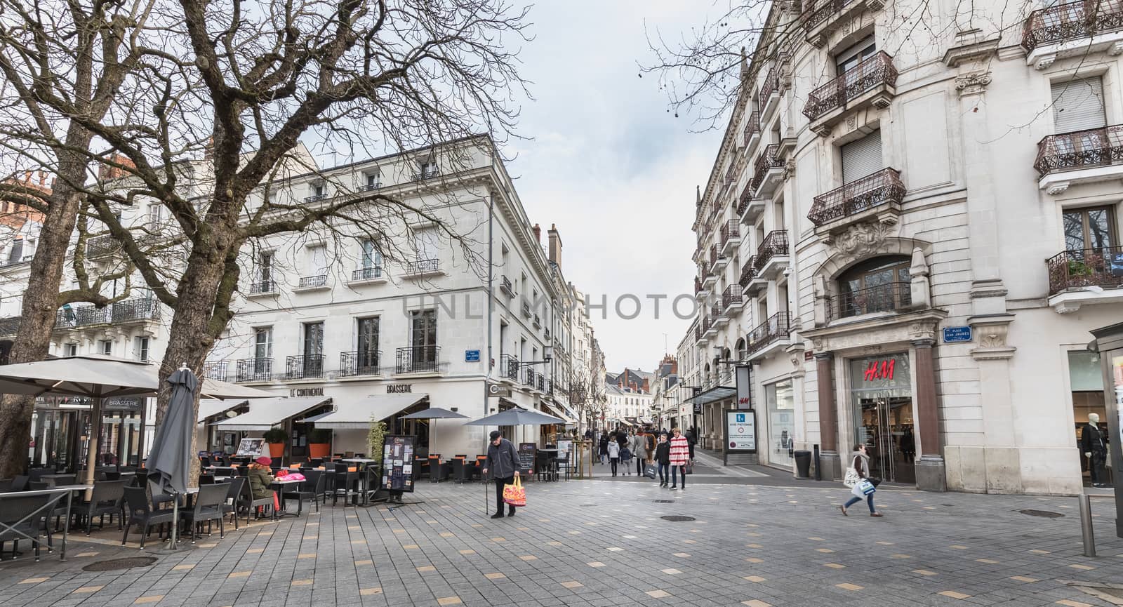 Tours, France - February 8, 2020: Street ambiance and architecture in a pedestrian street in the historic city center where people walk on a winter day on a winter day