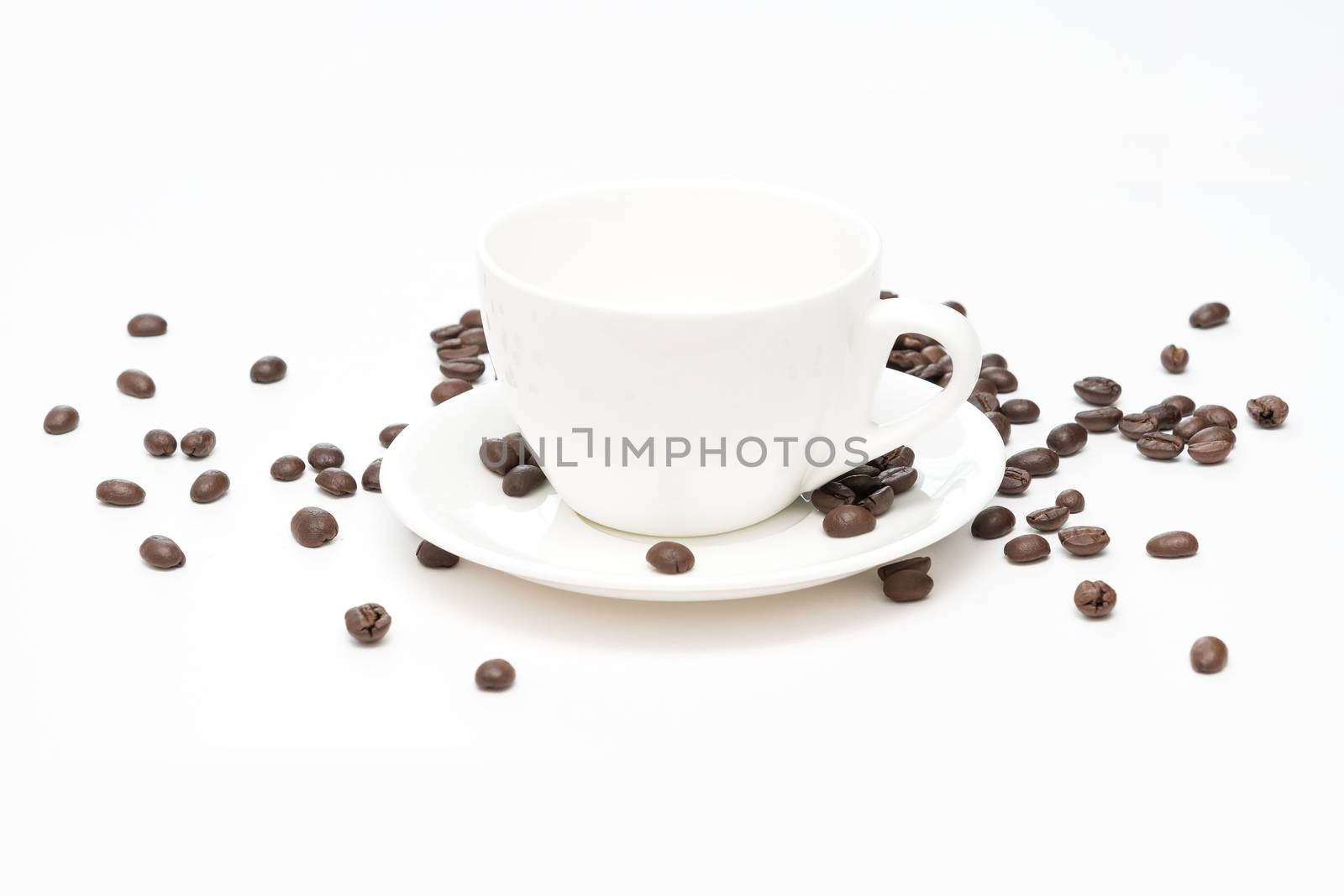 Coffee beans and white coffee cup isolated on white background.