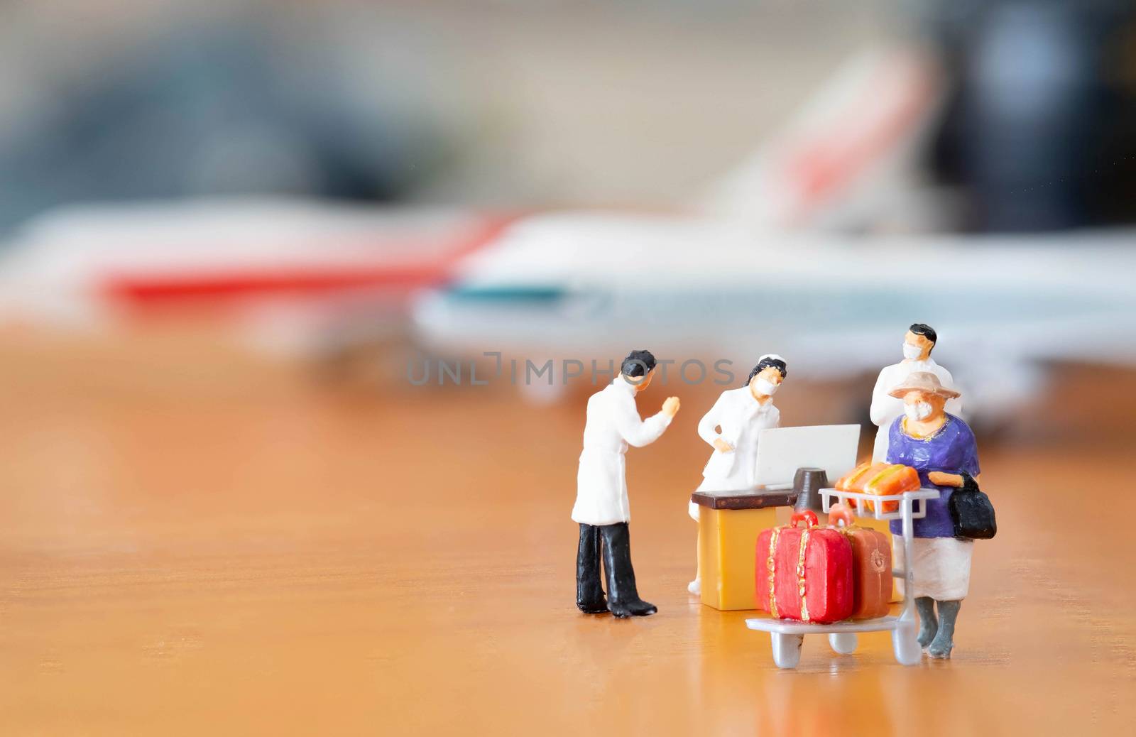 miniature figure doll passenger in airport wearing mask to prote by Bonn2210