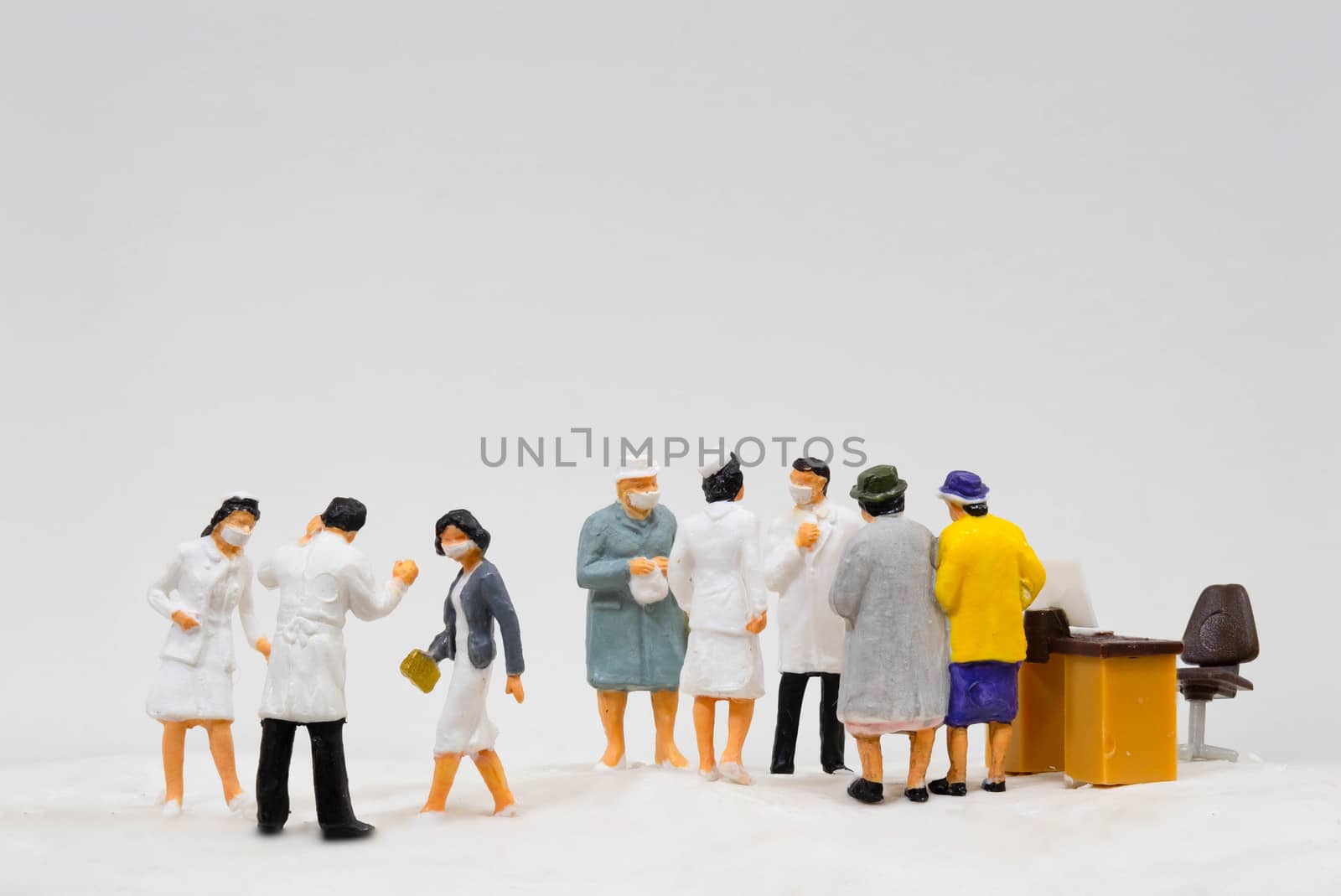 Miniature figure doll Group of Doctor Nurse and Patient wearing mask to Protect Covid-19 or Coronavirus in Hospital They are Talking consulting to other