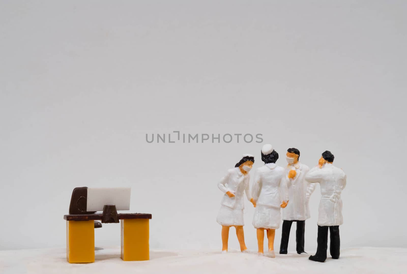 Miniature figure doll Group of Doctor Nurse and Patient wearing mask to Protect Covid-19 or Coronavirus in Hospital They are Talking consulting to other