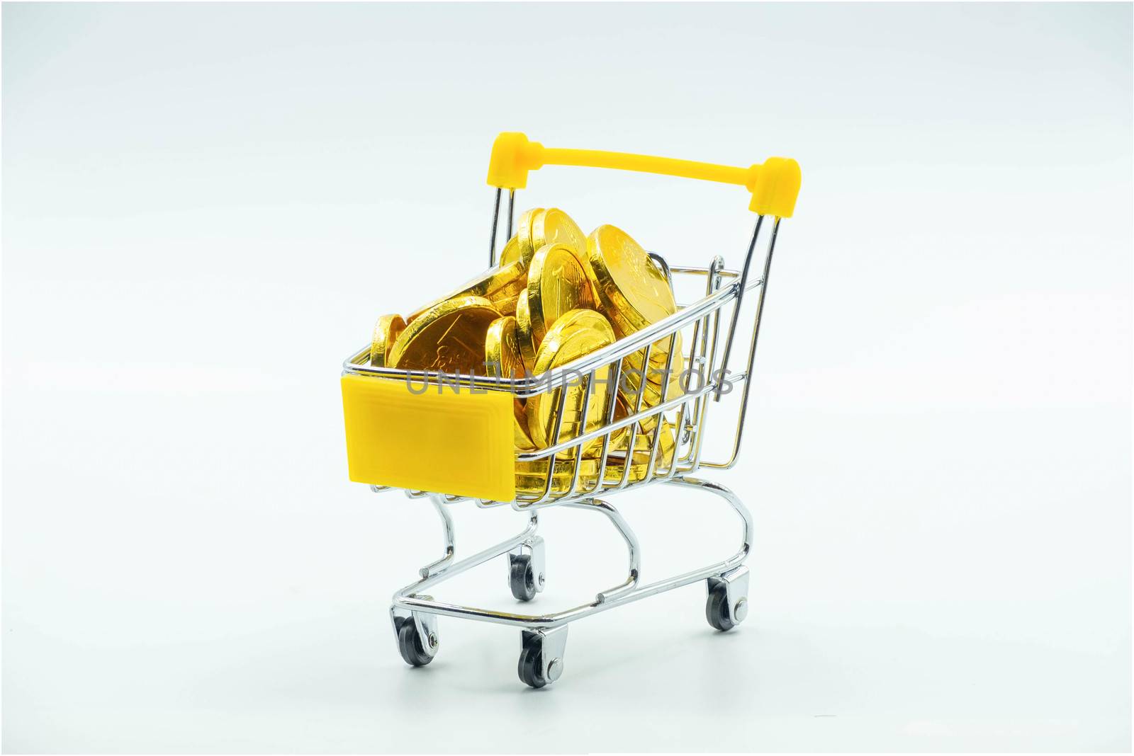 The Shopping cart and Gold coins Isolated on White background