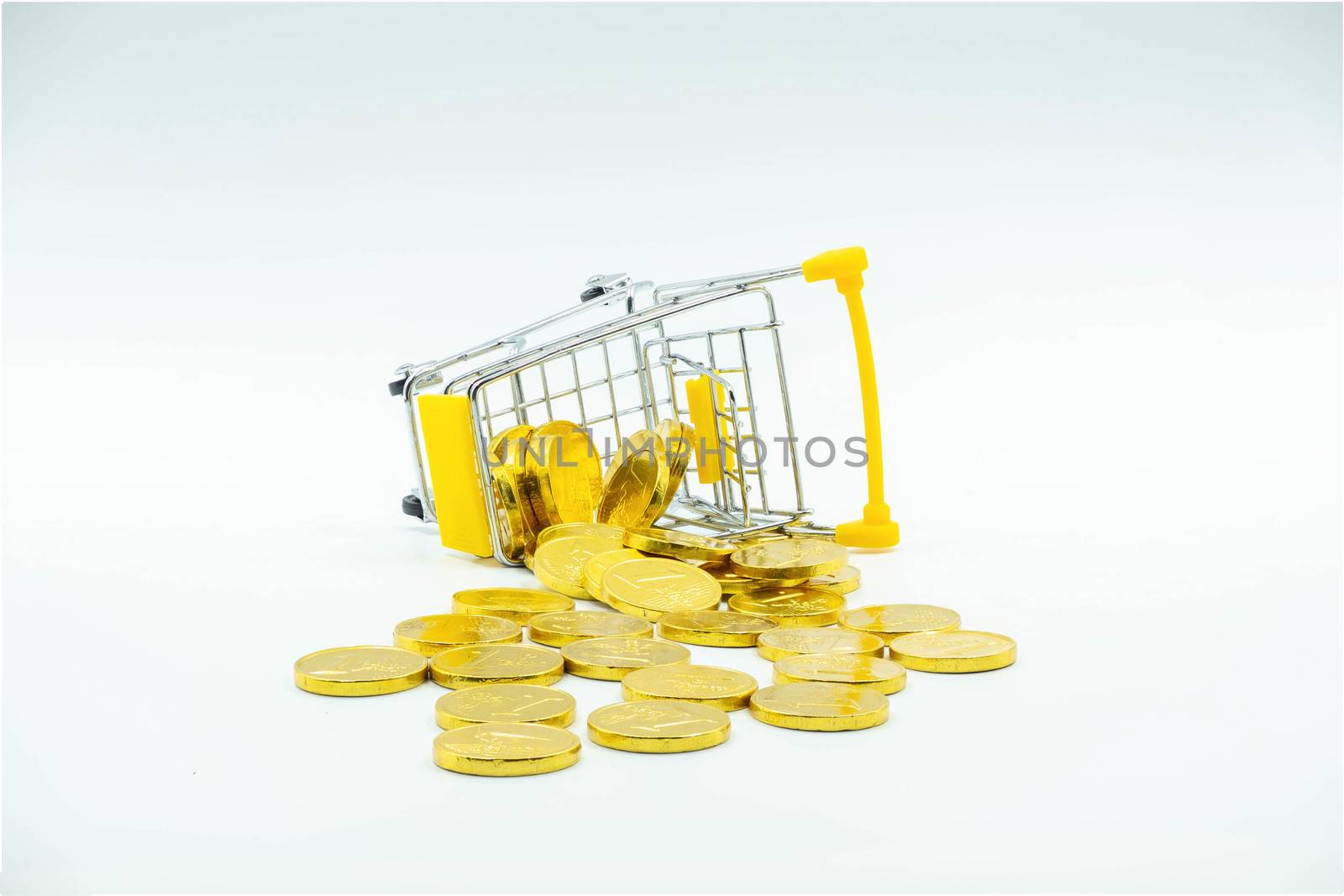 The Shopping cart fall and Gold coins on the Floor Isolated on White background