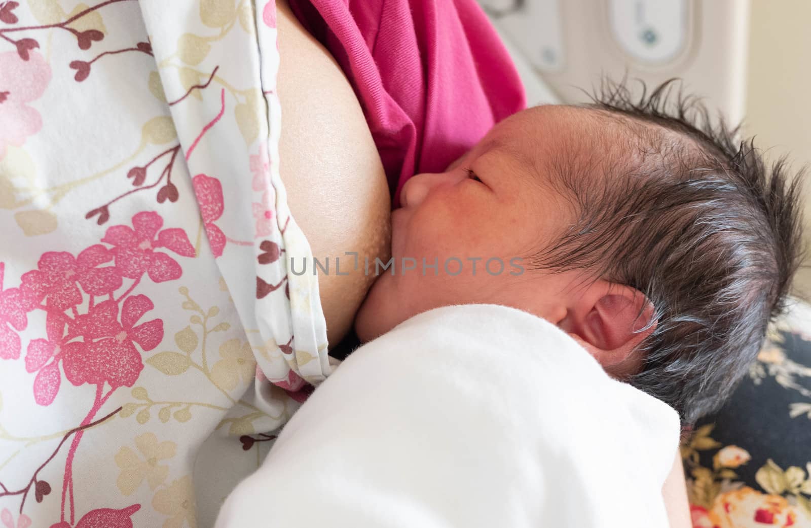 Feeding mother breast milk with the  new born baby on hands