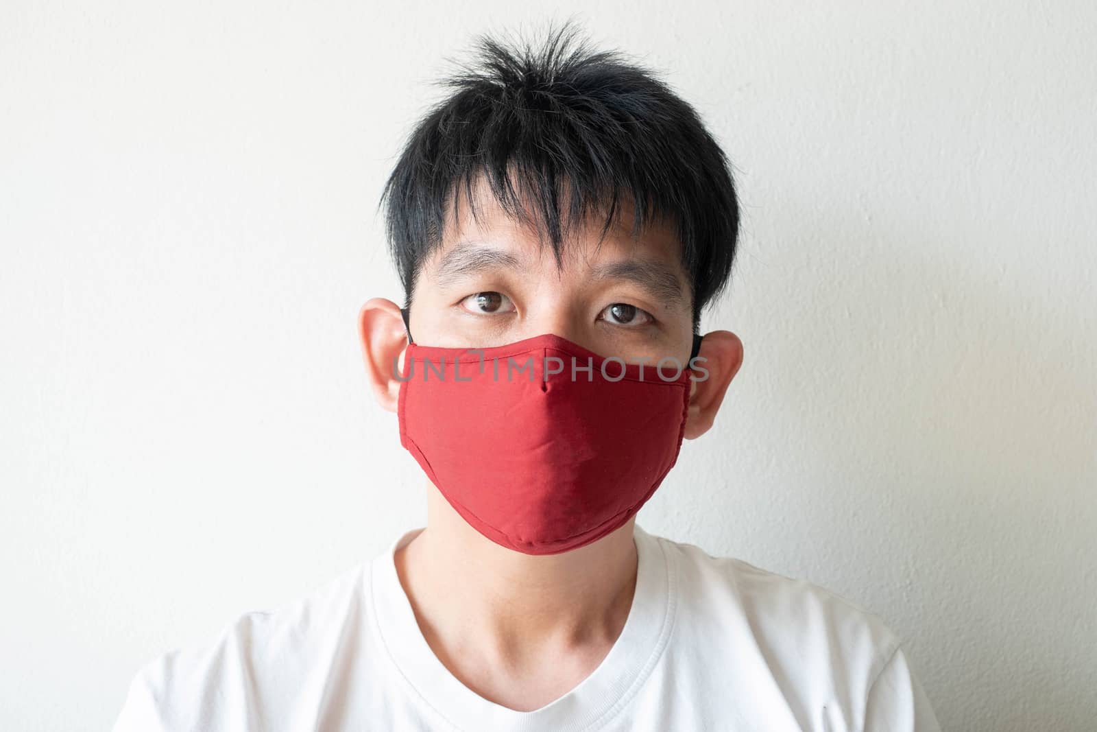 The Face of Asian Man Wearing Face Mask to protect himself from Coronavirus Covid-19 and pm 2.5 Pollution Isolate on White Background