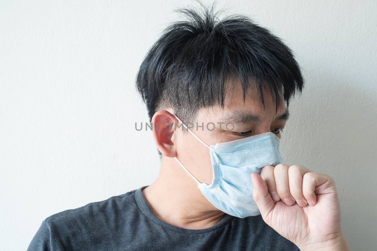 The Face of Sick Asian Chinese Man Wearing Face Mask feeling sick headache and  cough because of  Coronavirus Covid-19  Isolate on White Background