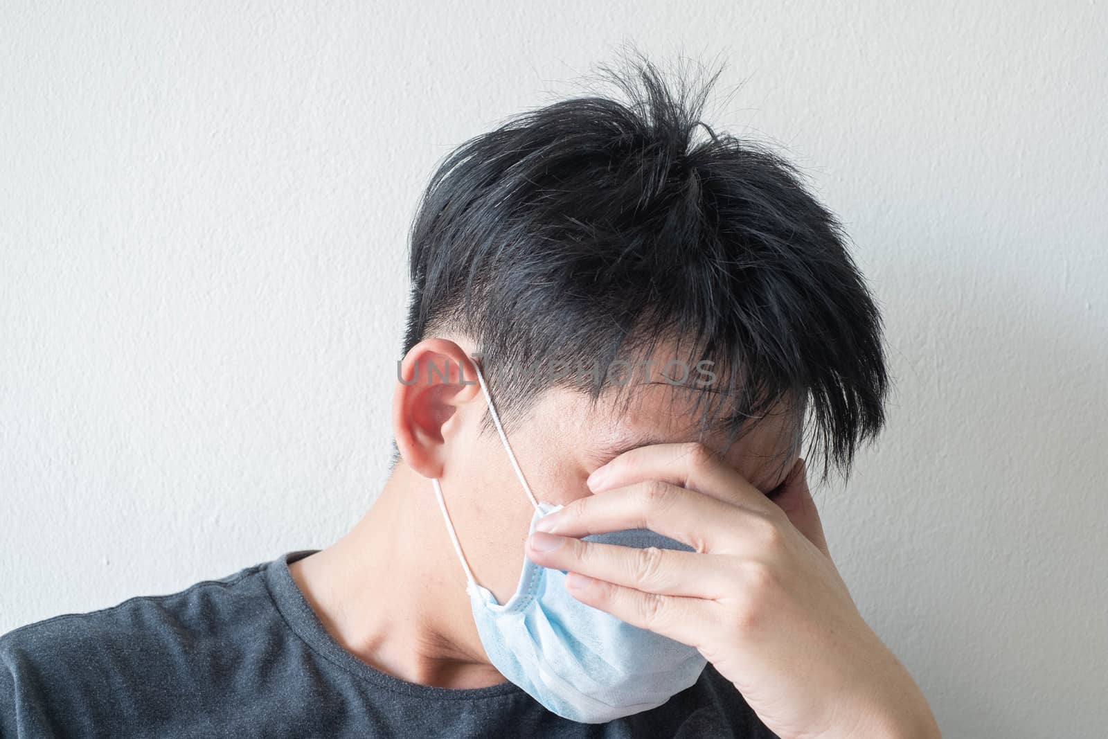 The Face of Sick Asian Chinese Man Wearing Face Mask feeling sick headache and  cough because of  Coronavirus Covid-19  Isolate on White Background