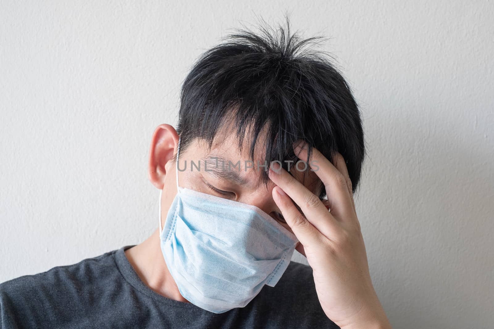 The Face of Sick Asian Chinese Man Wearing Face Mask feeling sick headache and  cough because of  Coronavirus Covid-19  Isolate on White Background