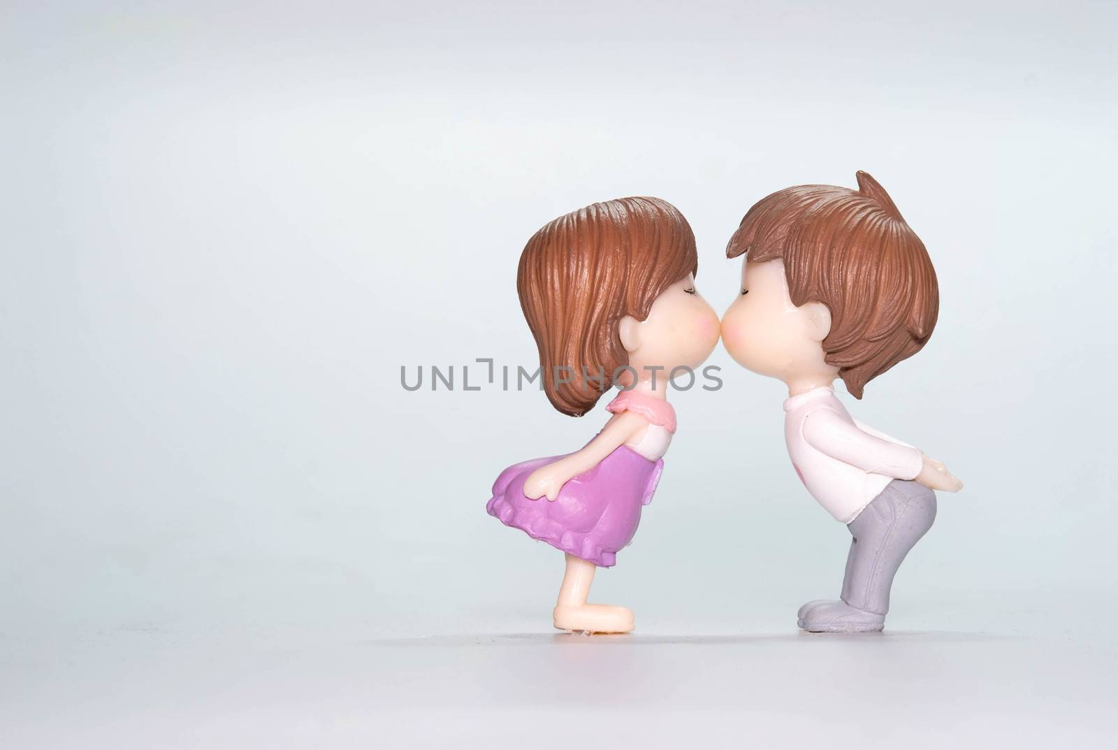 The Miniature doll of couple boy and girl kiss  isolate on White by Bonn2210