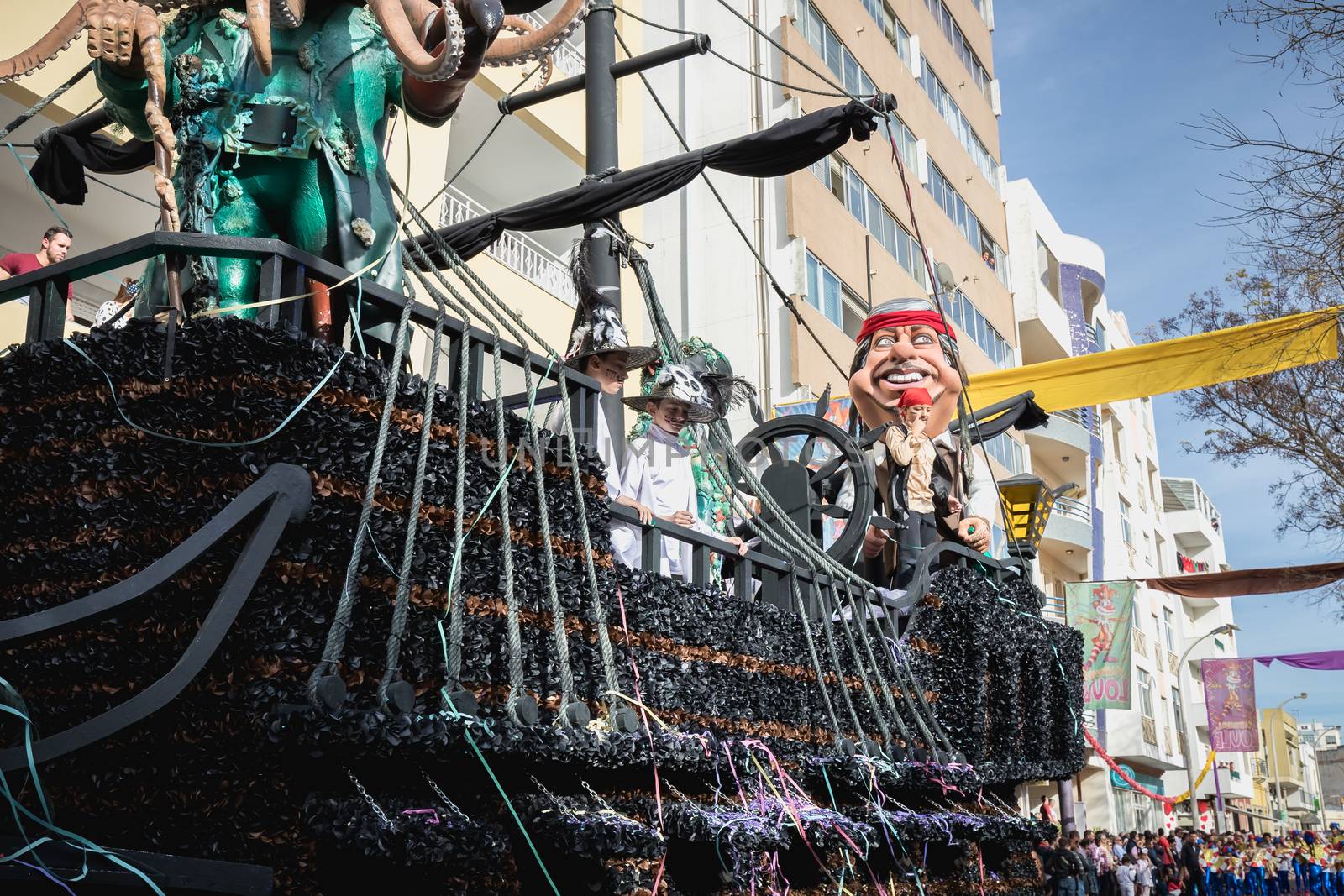 Loule, Portugal - February 25, 2020: Pirate ship float parading in the street in front of the public in the parade of the traditional carnival of Loule city on a February day