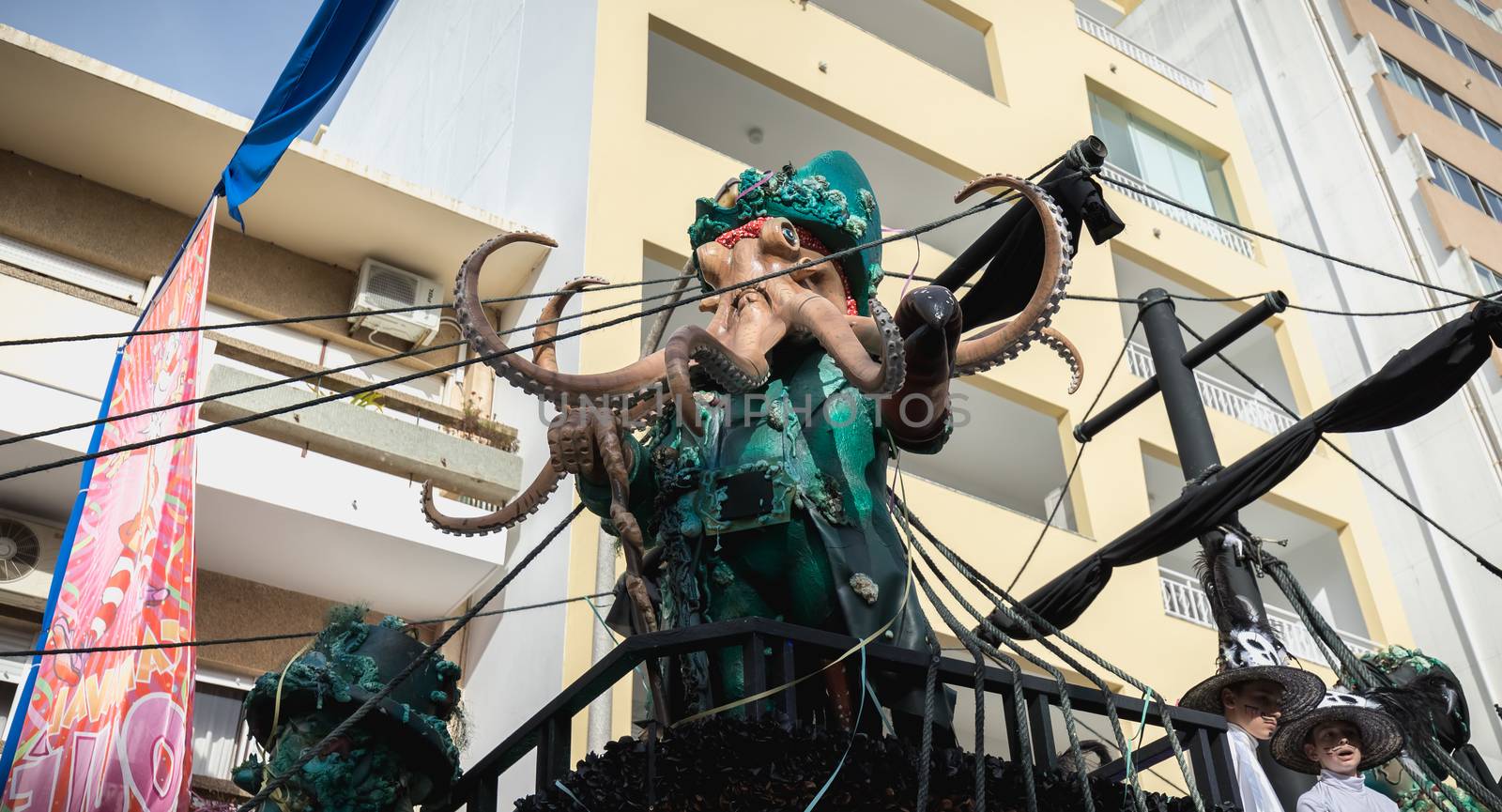 Loule, Portugal - February 25, 2020: Pirate ship float parading in the street in front of the public in the parade of the traditional carnival of Loule city on a February day