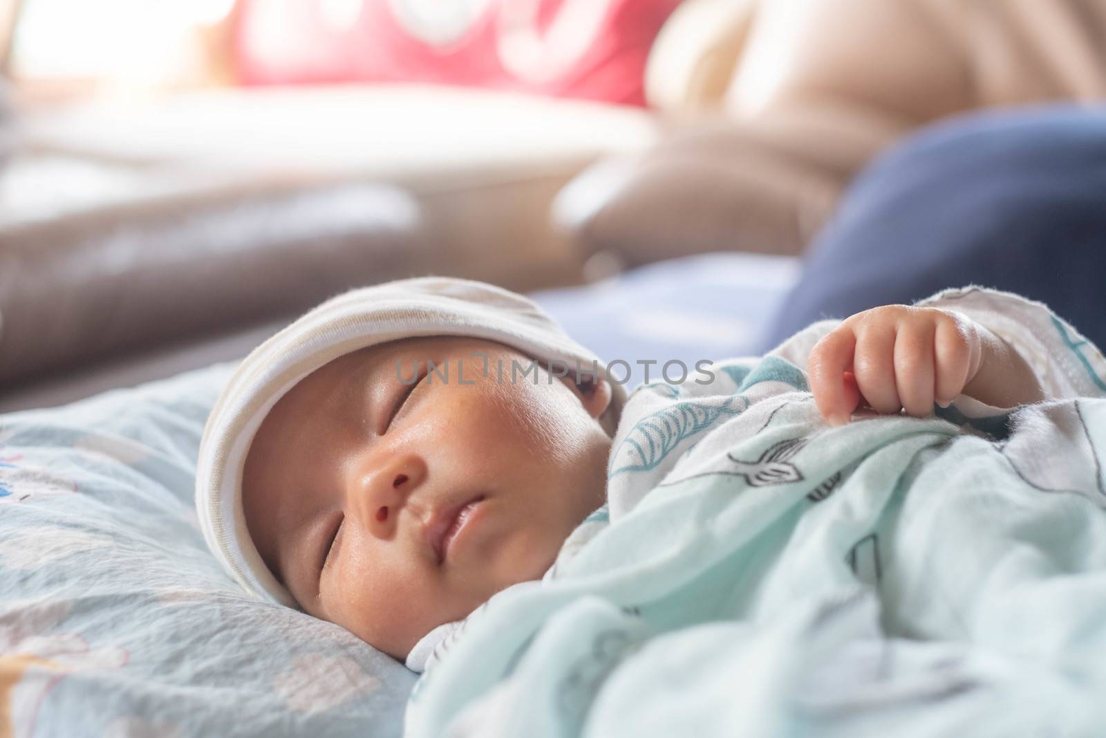 The Sleeping cute New Born Baby infant with hat  on the bed