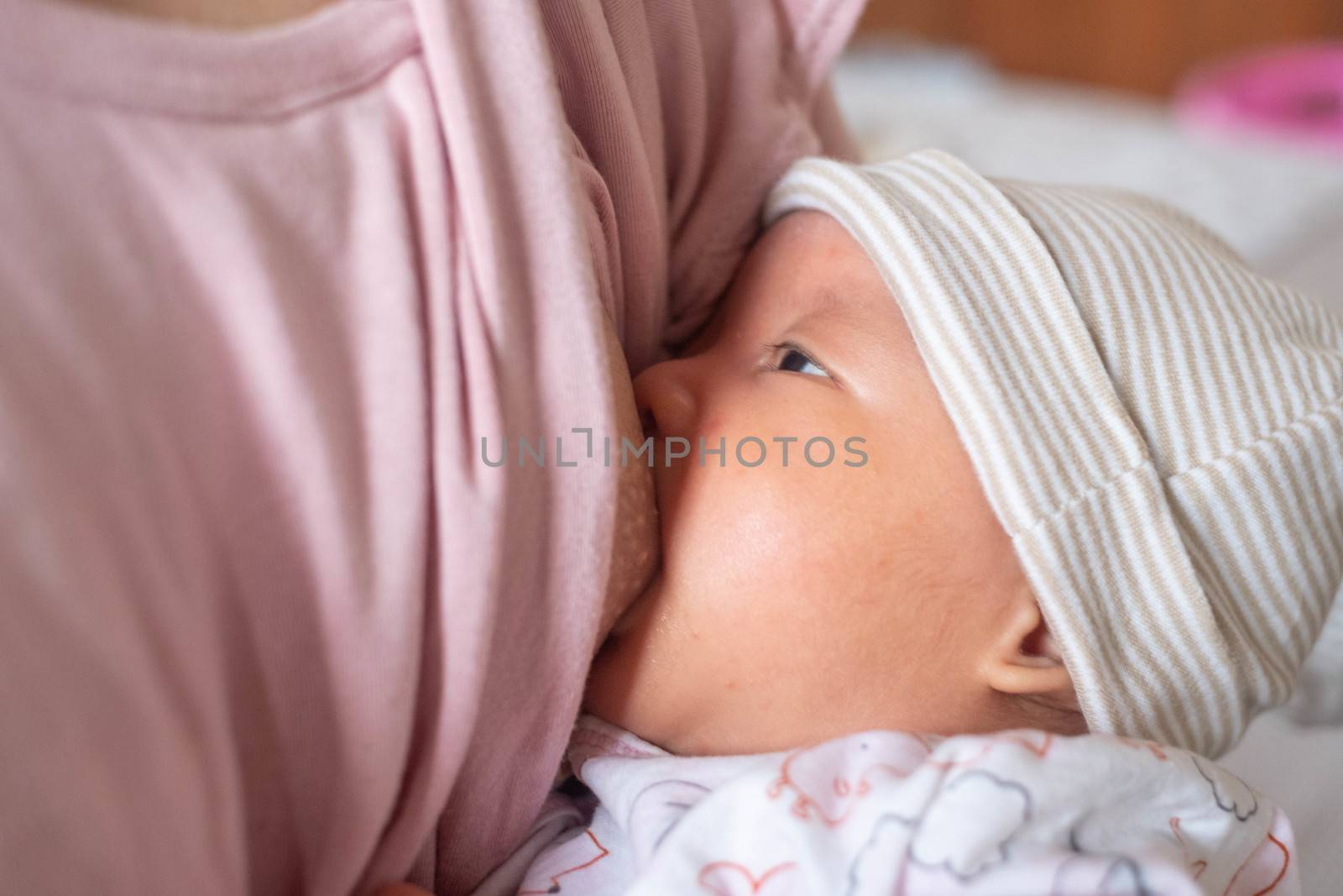 Baby feeds on mother's breasts milk