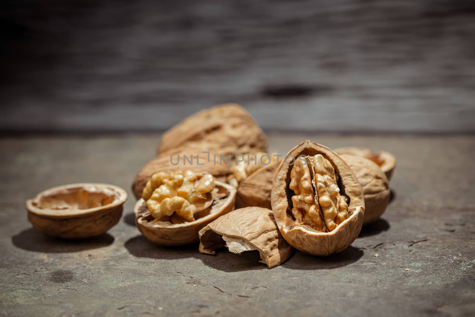 still life with Walnut kernels and whole walnuts on rustic old w by photosam