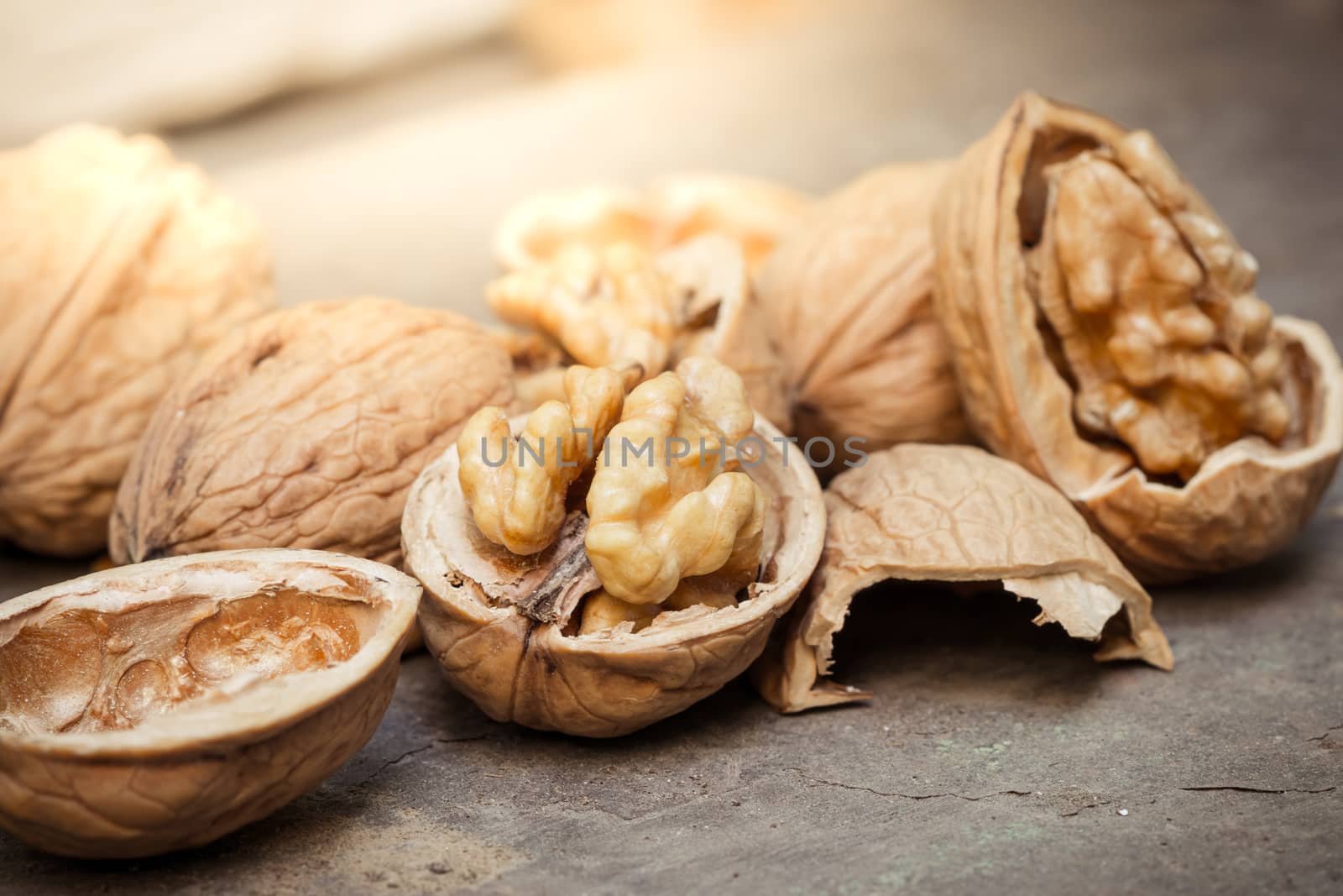 still life with Walnut kernels and whole walnuts on rustic old w by photosam