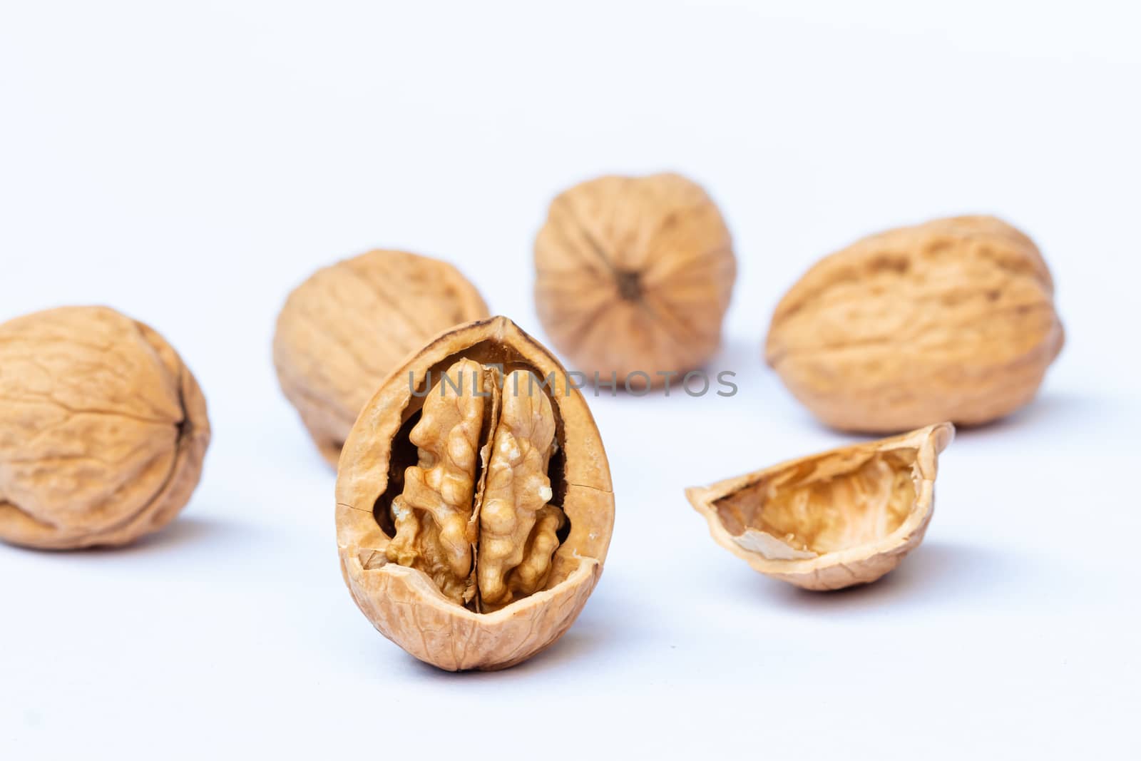 still life with Walnut kernels and whole walnuts on rustic table