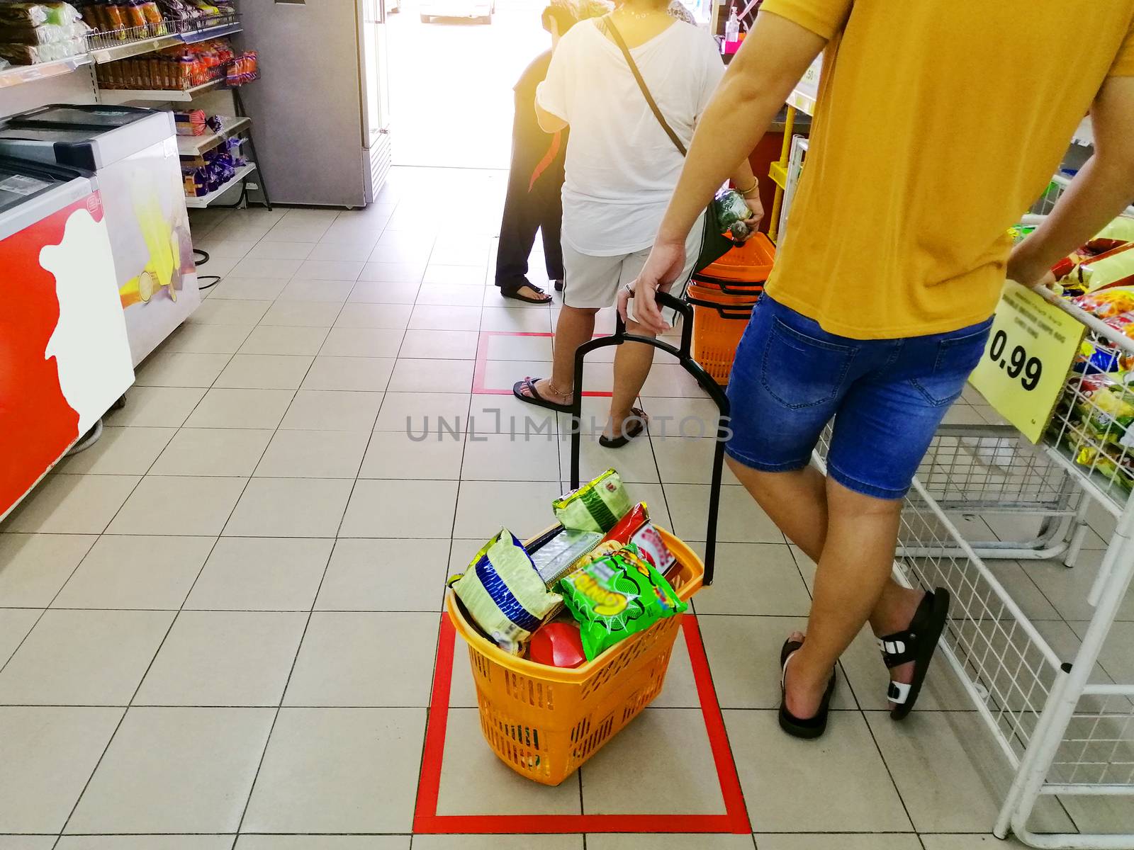  Grocery shoppers practise social distancing as they queue to make payment for coronavirus infection risk at supermarket.