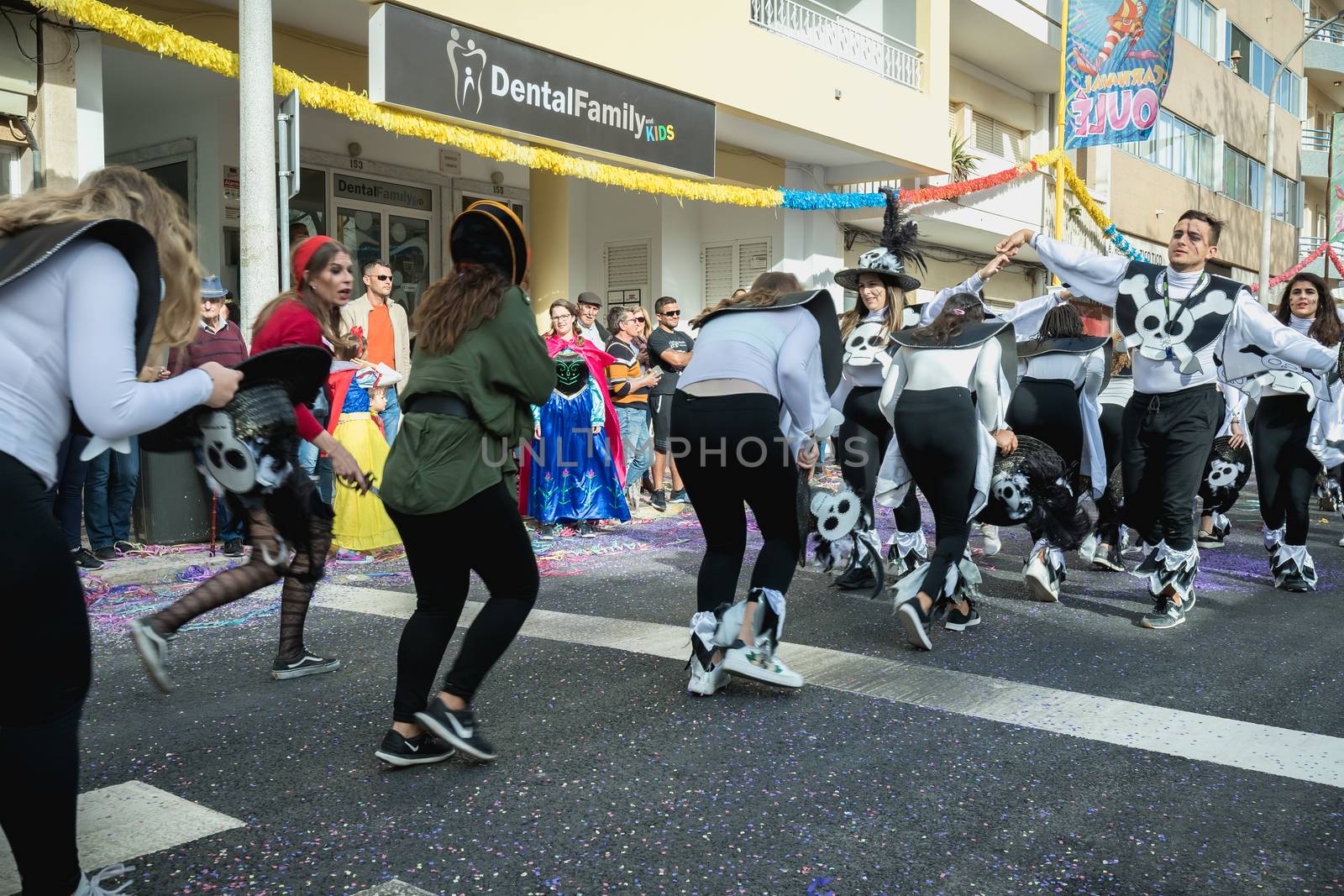 Loule, Portugal - February 25, 2020: dancers parading in the street in front of the public in the parade of the traditional carnival of Loule city on a February day