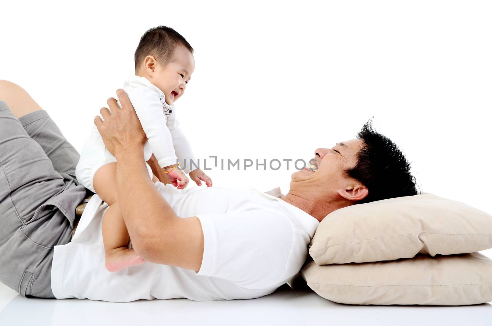 Asian father playing with his baby boy