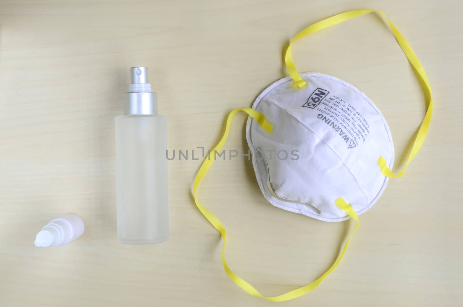 N95 respirator  with alcohol sanitizer gel on wooden background for covid-19 Coronavirus prevention concept.