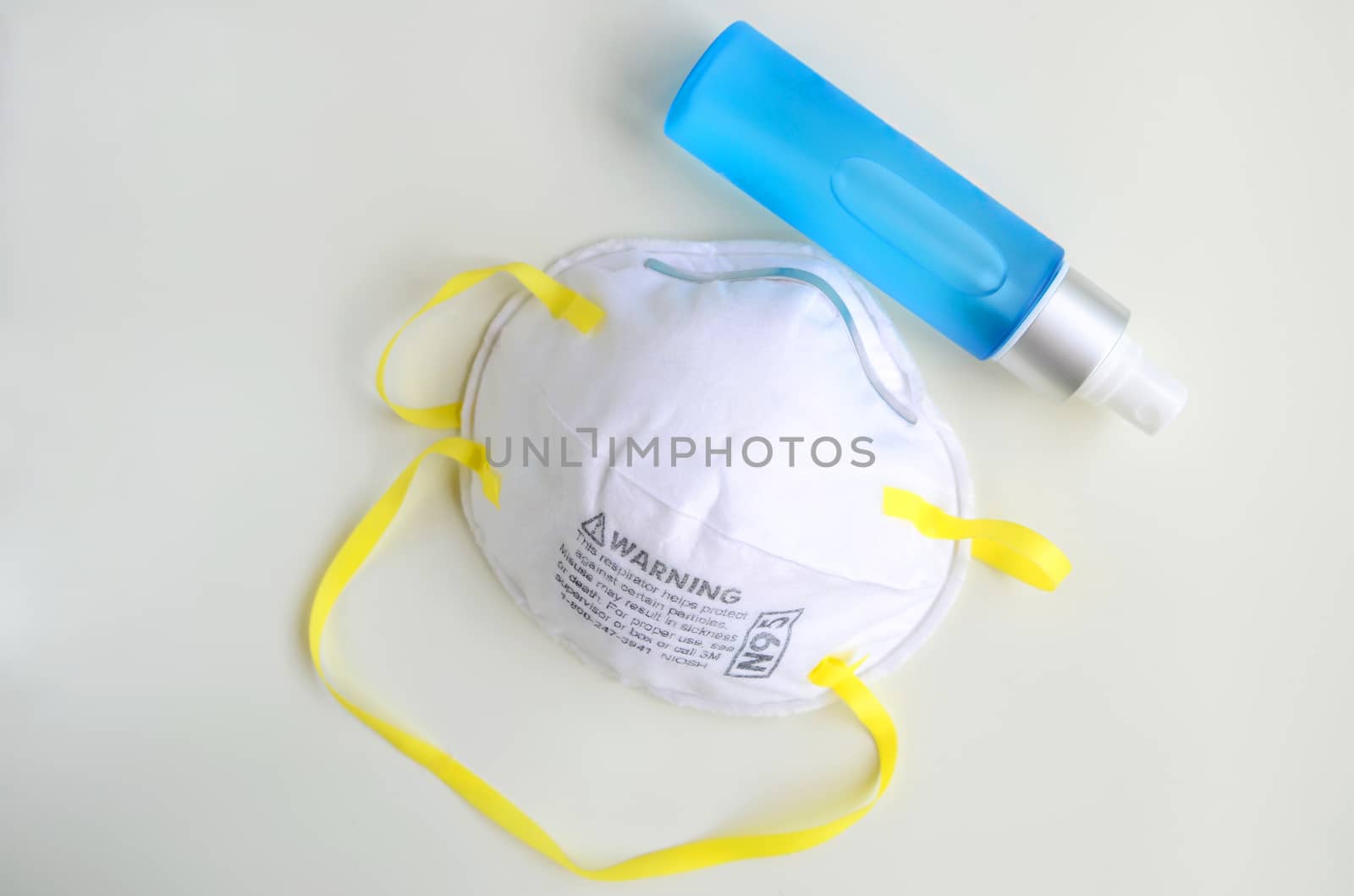 N95 respirator  with alcohol sanitizer gel on grey background for covid-19 Coronavirus prevention concept.