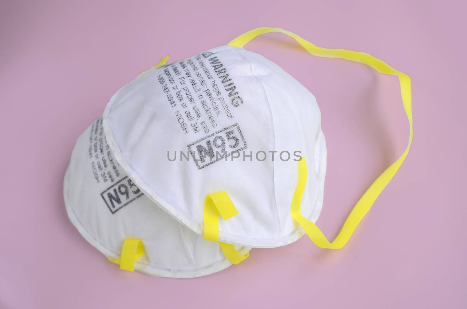 N95 safety masks on pink  background. dust protection respirator and breathing medical respiratory mask.