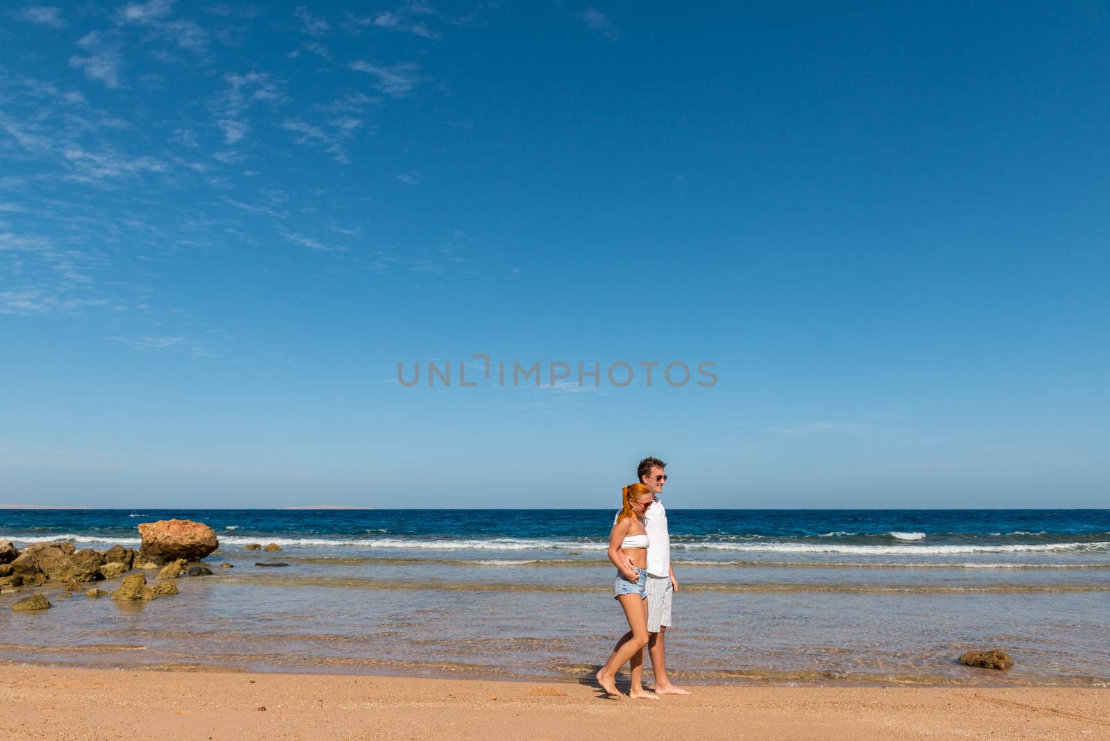 Romantic young couple on the beach by nikitabuida